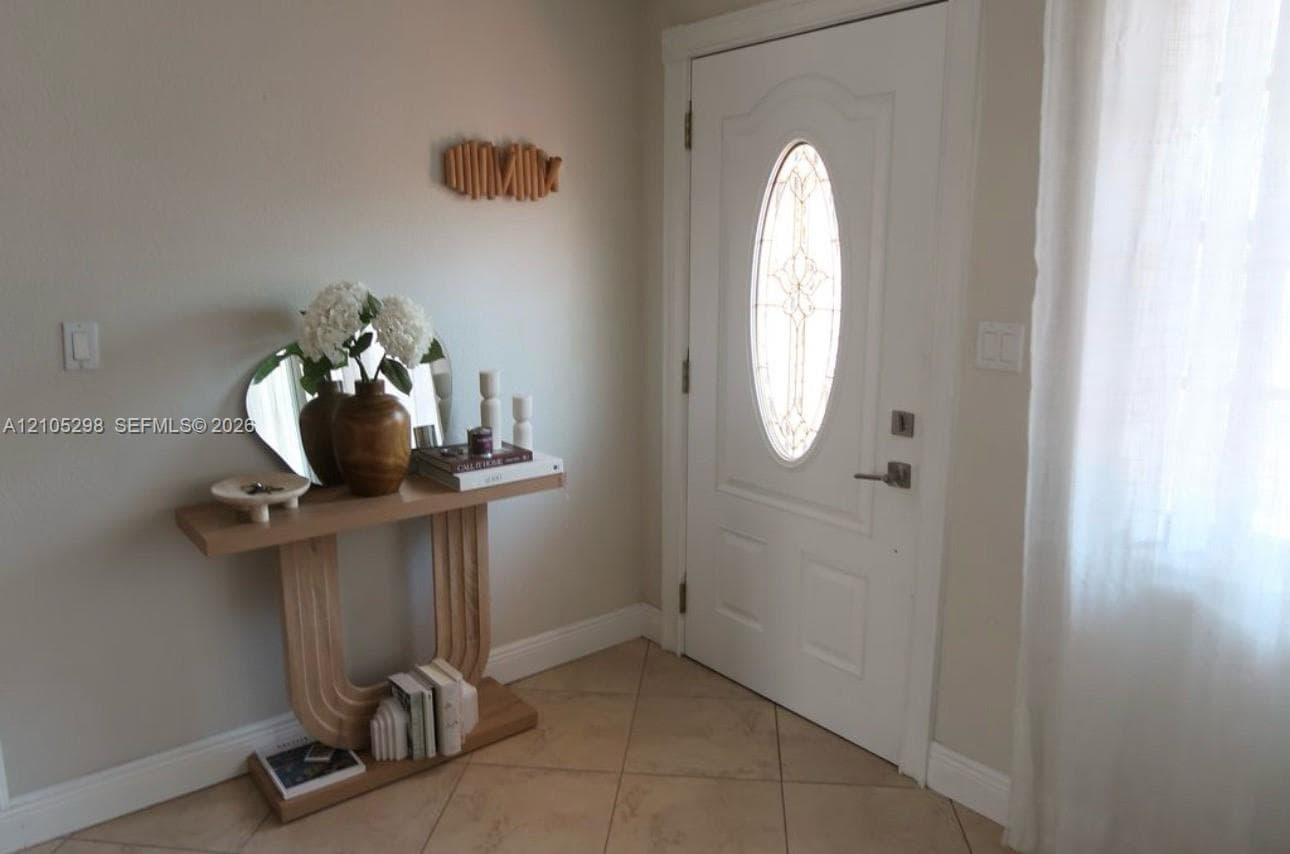 White entry door with an oval decorative glass insert