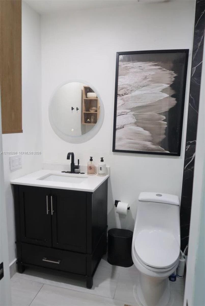 Vanity with a white countertop and black cabinetry
