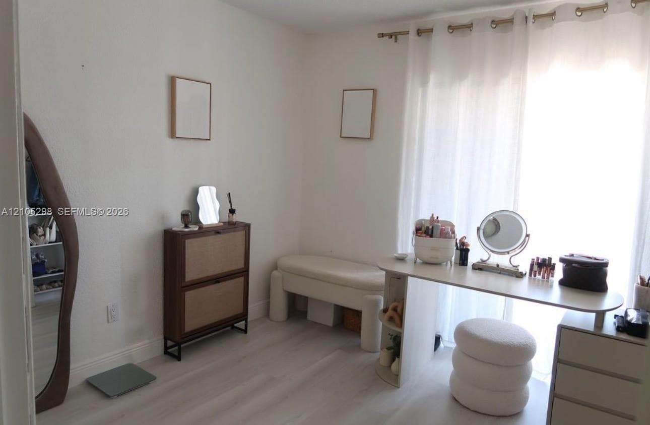 Light wood-finish flooring with white walls