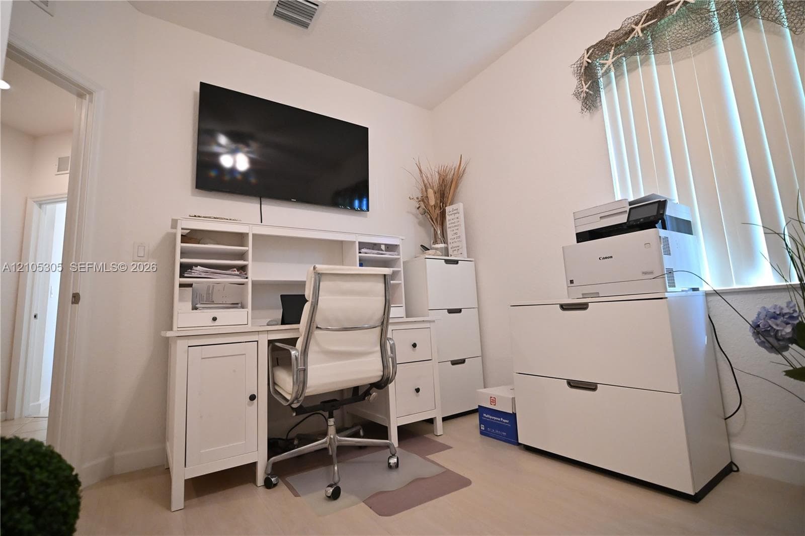 White wall finishes with light wood-finish flooring