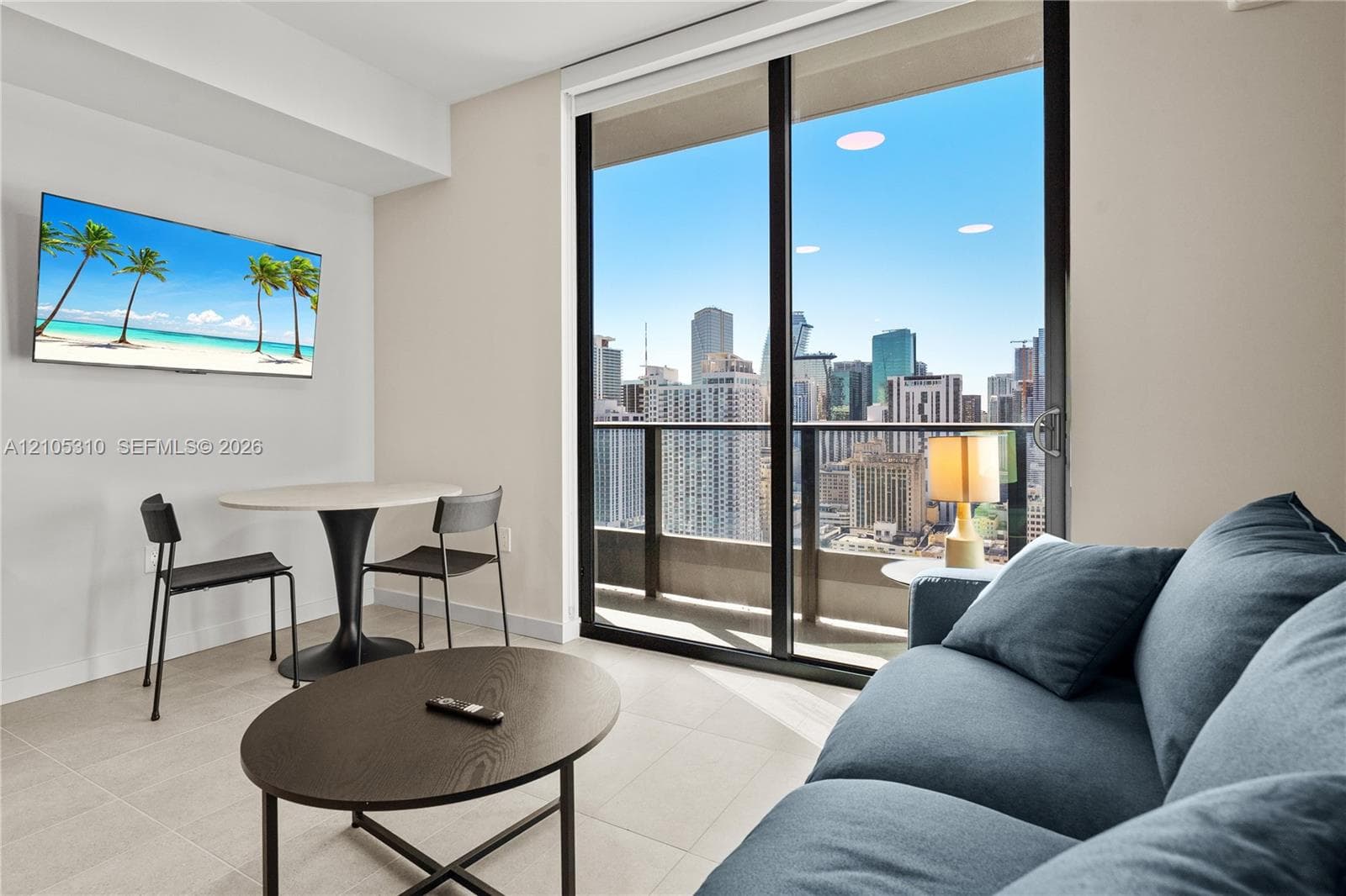 Floor-to-ceiling glass sliding doors, private balcony, neutral wall tones, recessed lighting, and tile flooring