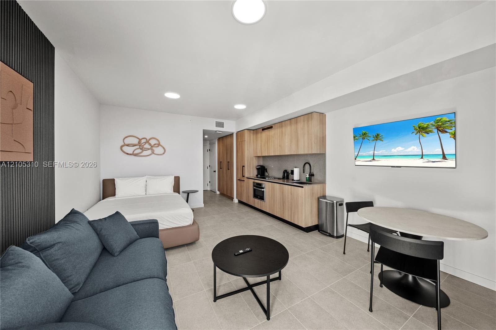 Integrated living space with light-toned tile flooring
