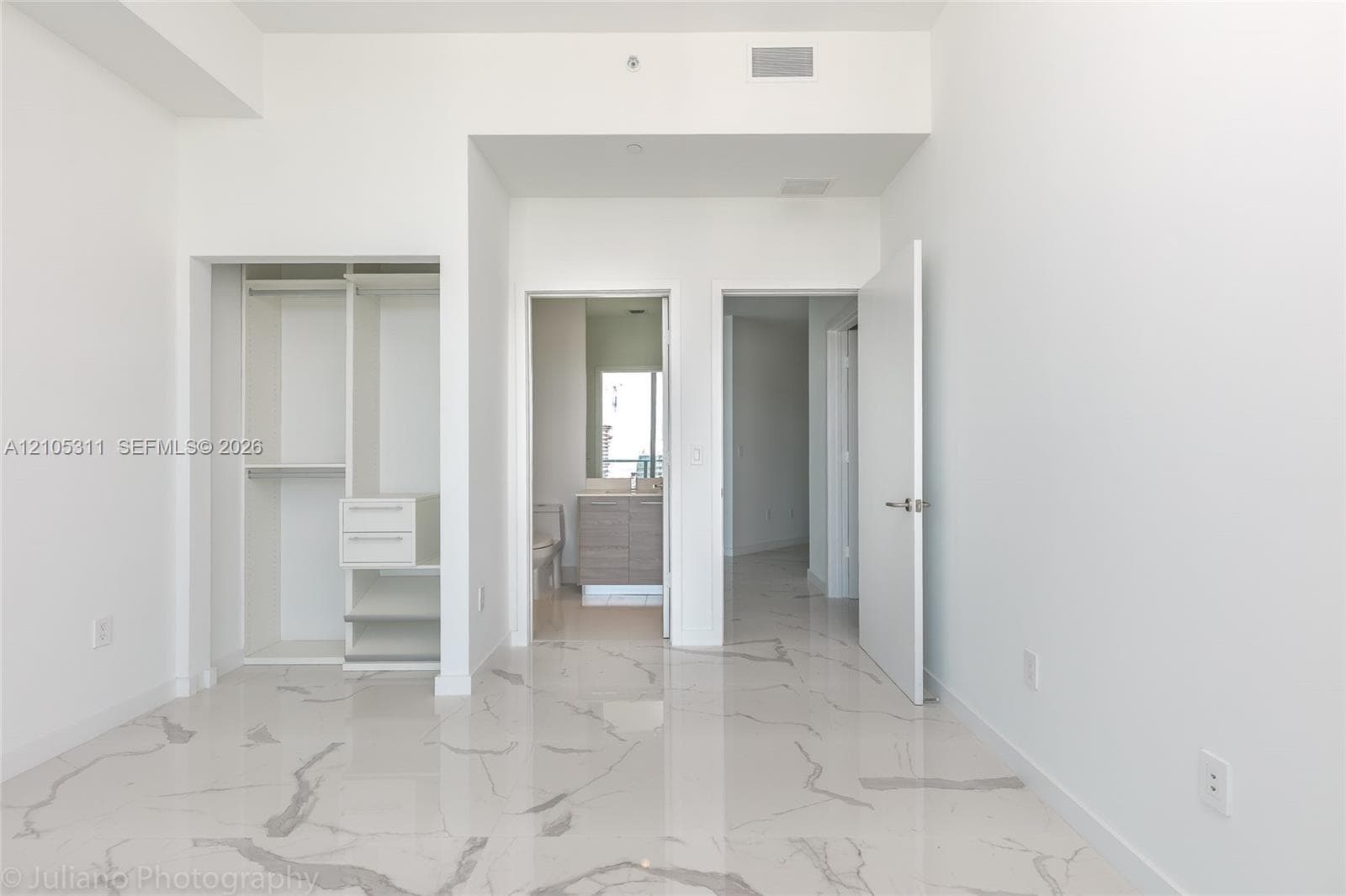 White walls with marble-look flooring