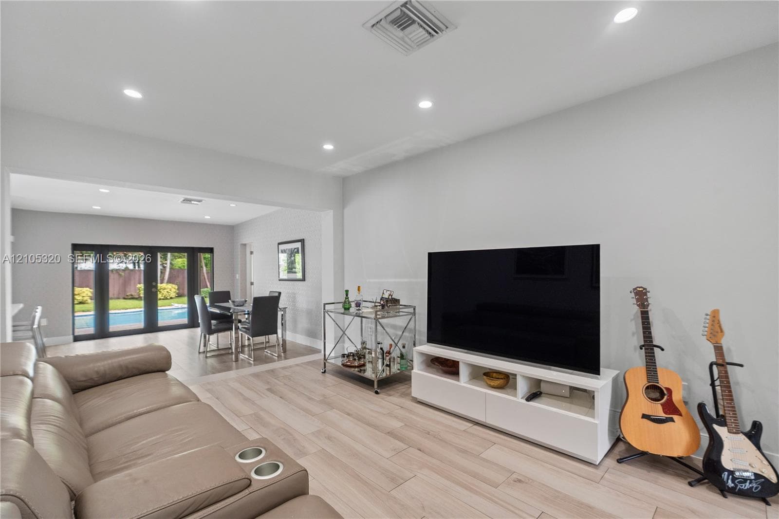 Recessed lighting, light wood-finish flooring, and white walls