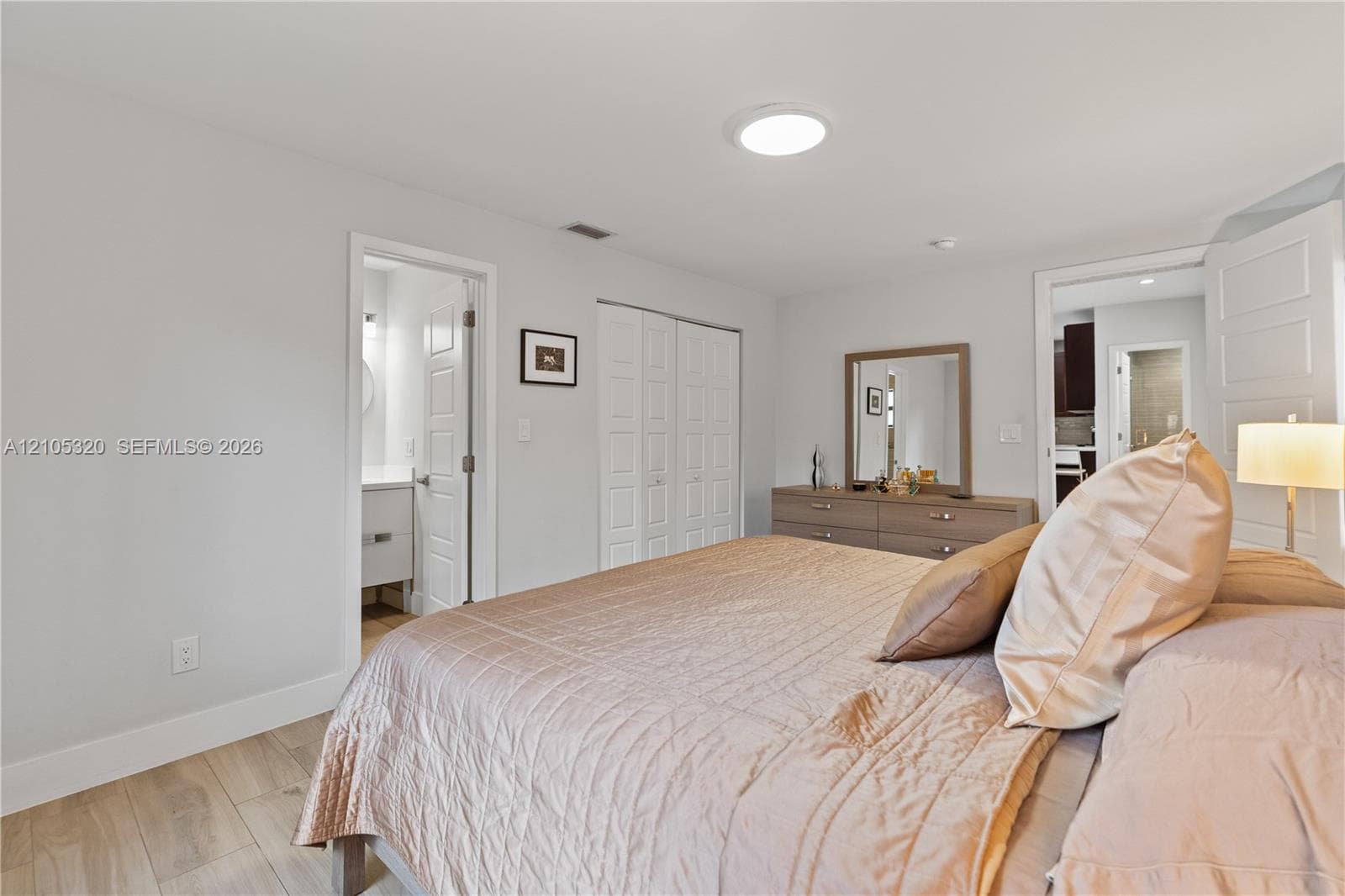 Light wood-finish flooring with white baseboards
