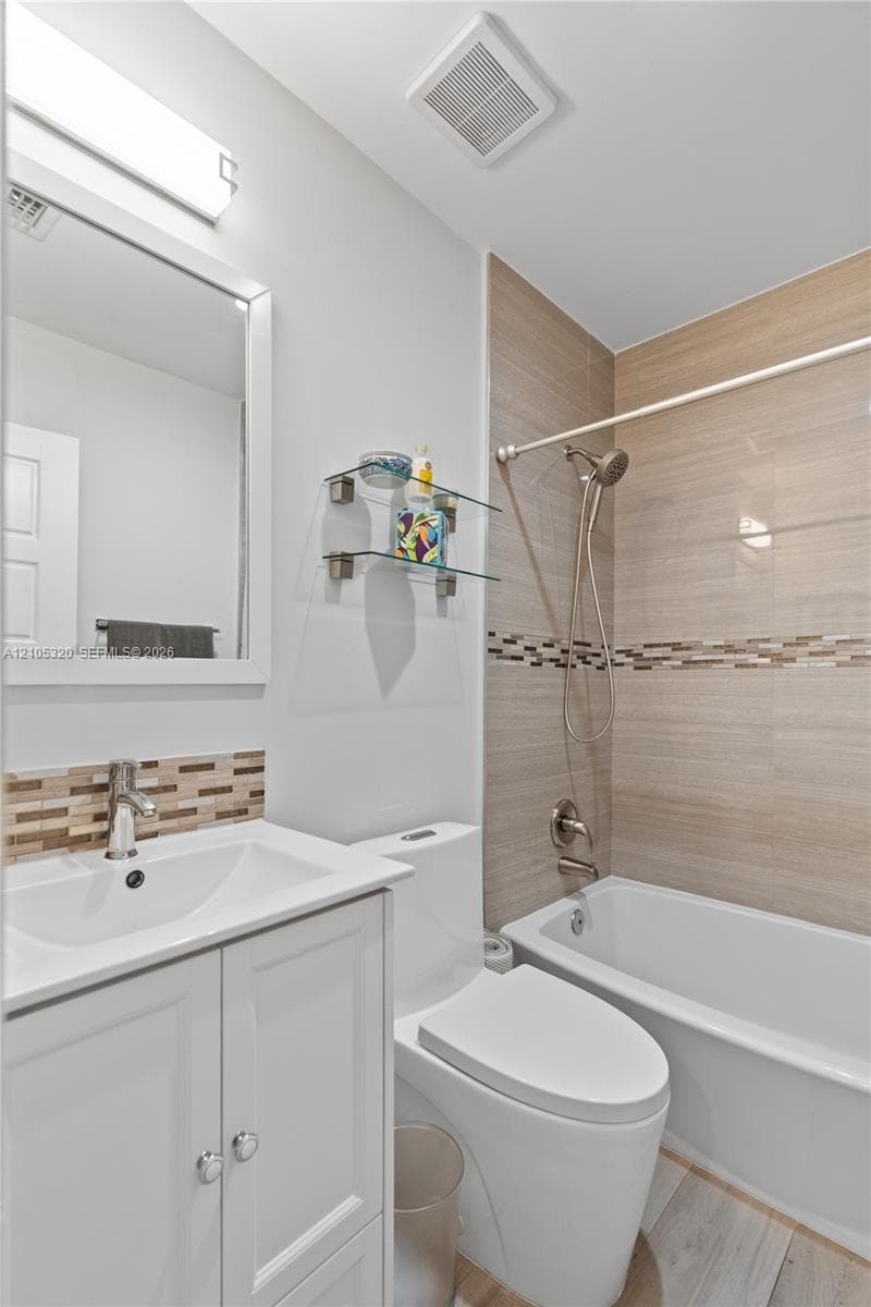 White vanity with chrome hardware, rectangular sink, and chrome faucet