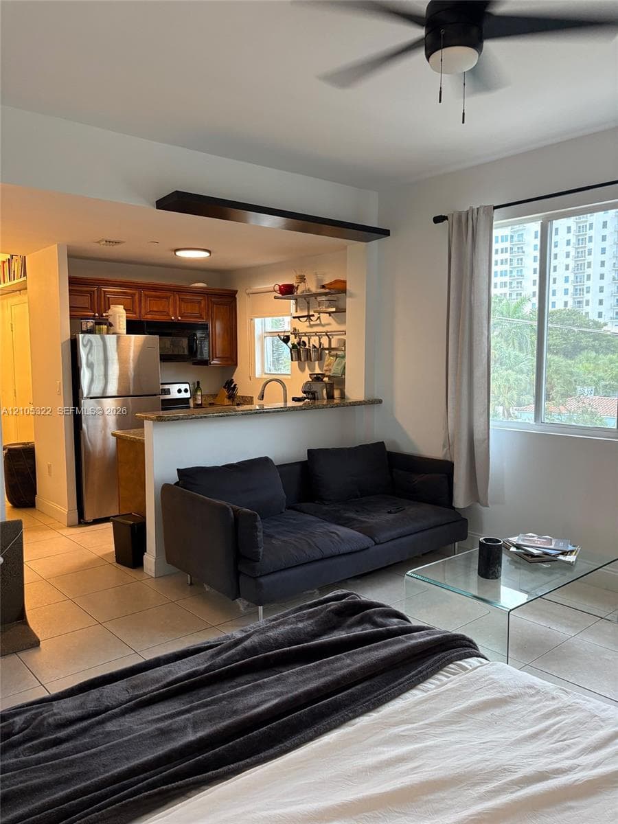 Kitchen with wood cabinetry, stainless steel appliances, and a pass-through counter