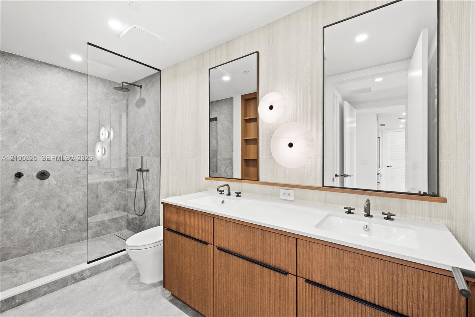 Dual vanity with white countertop, integrated sinks, and matte black fixtures