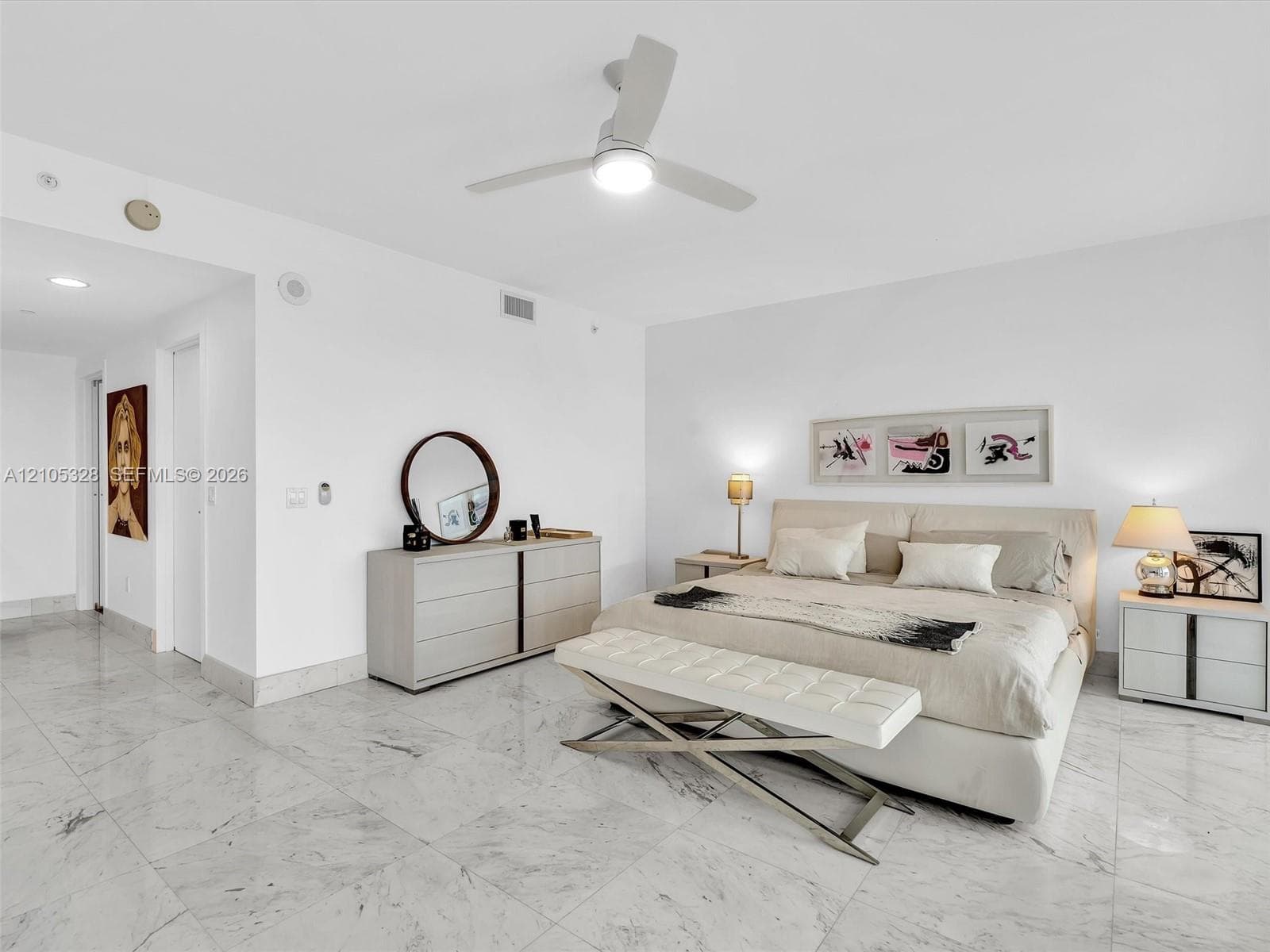 Wake up to breathtaking ocean views from the comfort of your bed in this spacious primary suite, featuring floor-to-ceiling sliding glass doors with direct access to a private balcony.