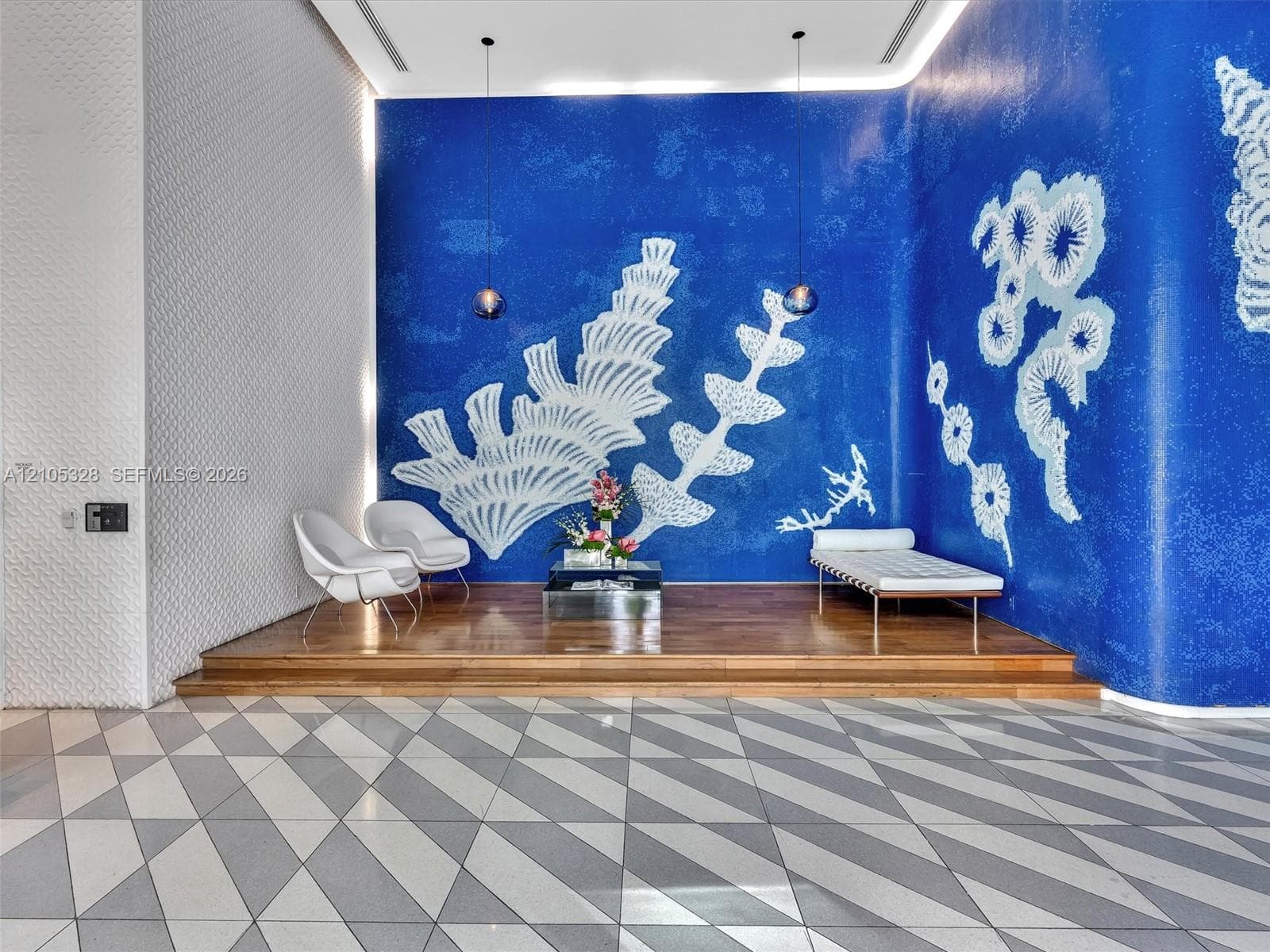 Step into an elegant, contemporary lobby with the intimate ambiance of a luxury boutique hotel, featuring distinctive designer finishes, stylish architectural details, sophisticated accent lighting, and a welcoming atmosphere.