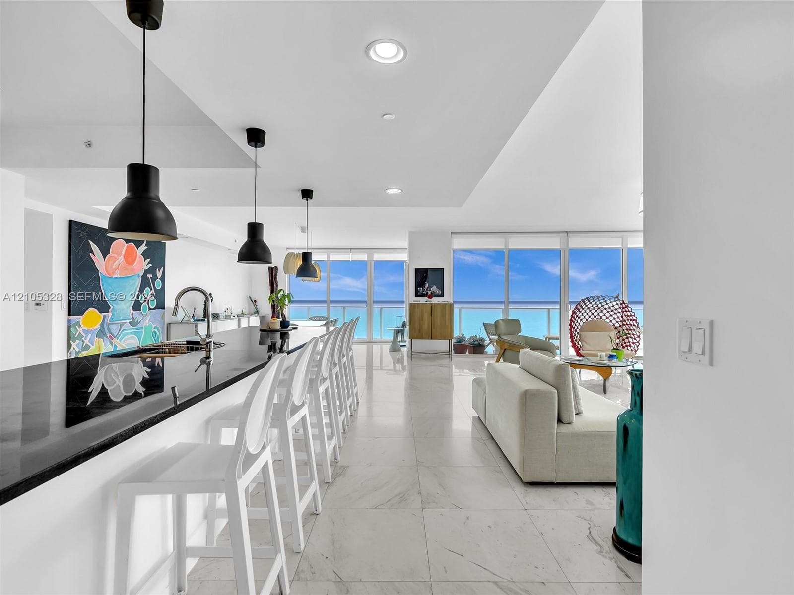Expansive living area featuring elegant large-format marble-look tile flooring.