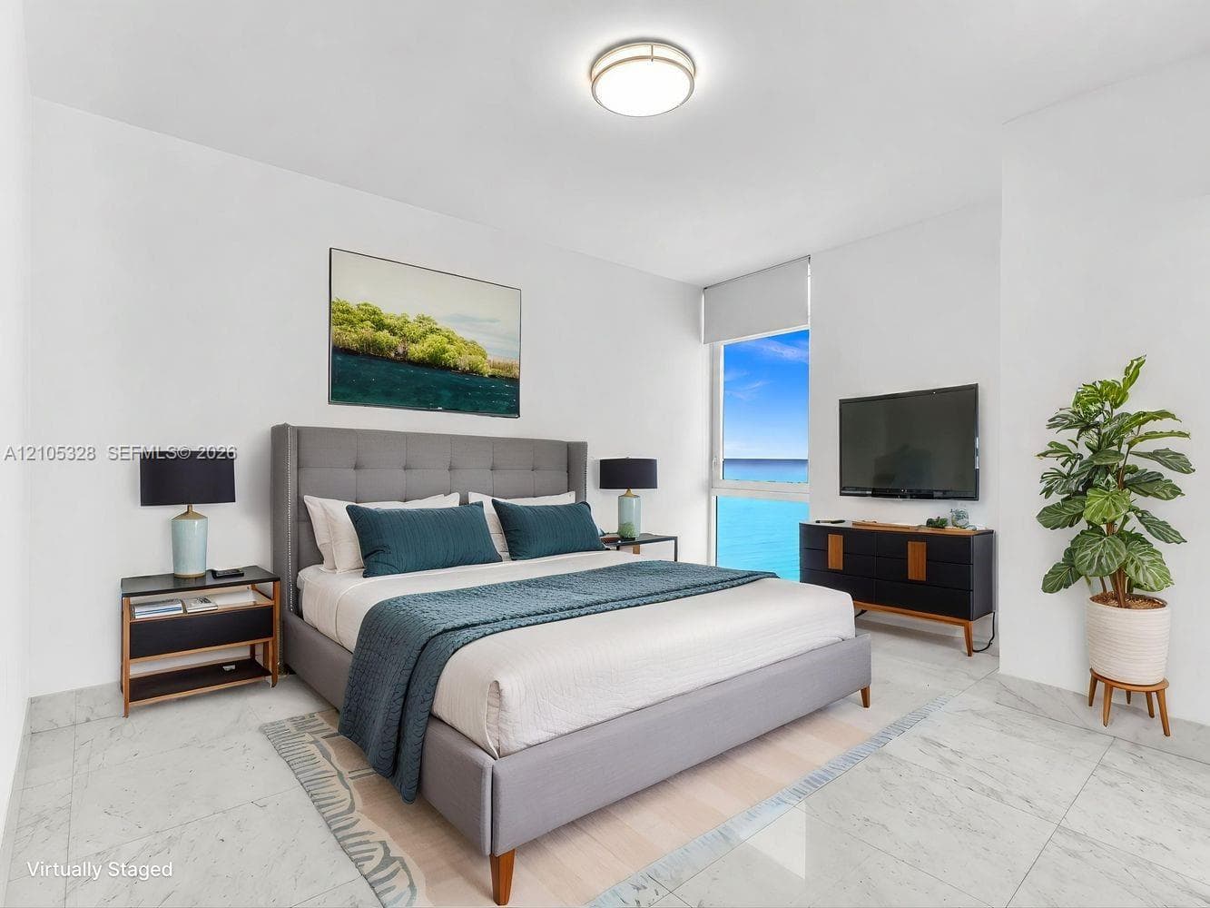 Bright and airy interior featuring soaring ceilings, dramatic floor-to-ceiling windows that fill the space with natural light, elegant hard-surface flooring, and recessed ceiling lighting.