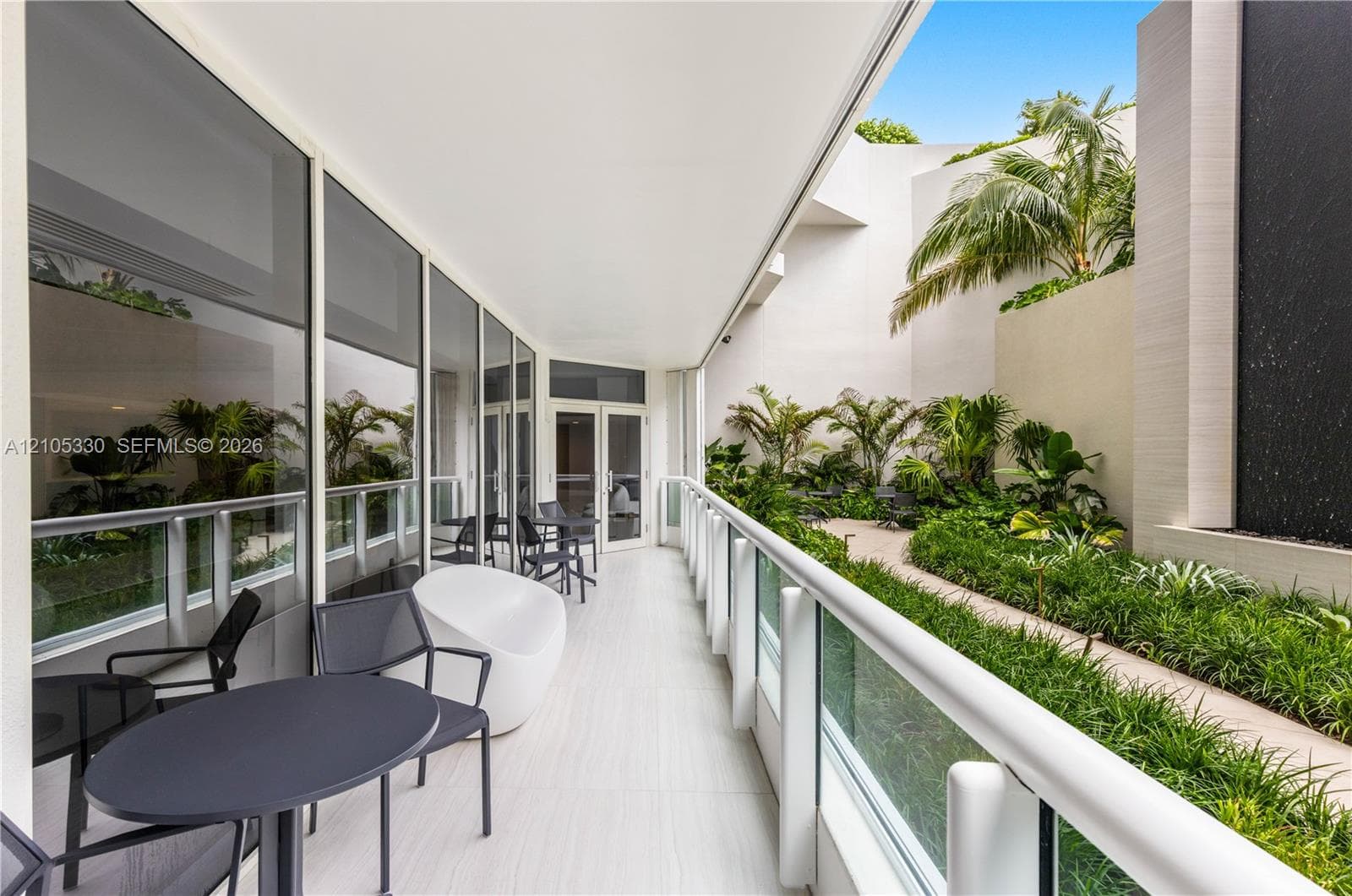Outdoor patio with wood-finish flooring and glass railing