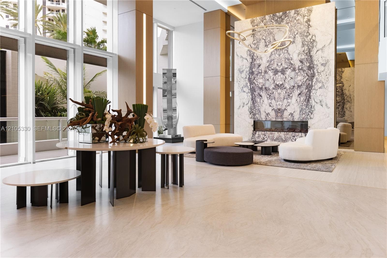 Expansive floor-to-ceiling windows, large format tile flooring, stone accent wall with built-in linear fireplace, and integrated ceiling lighting