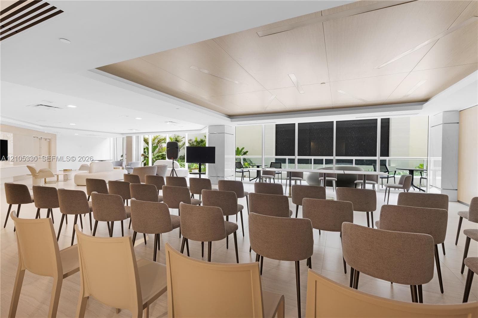 Spacious room with recessed lighting, large windows, wood-finish flooring, and a unique ceiling design