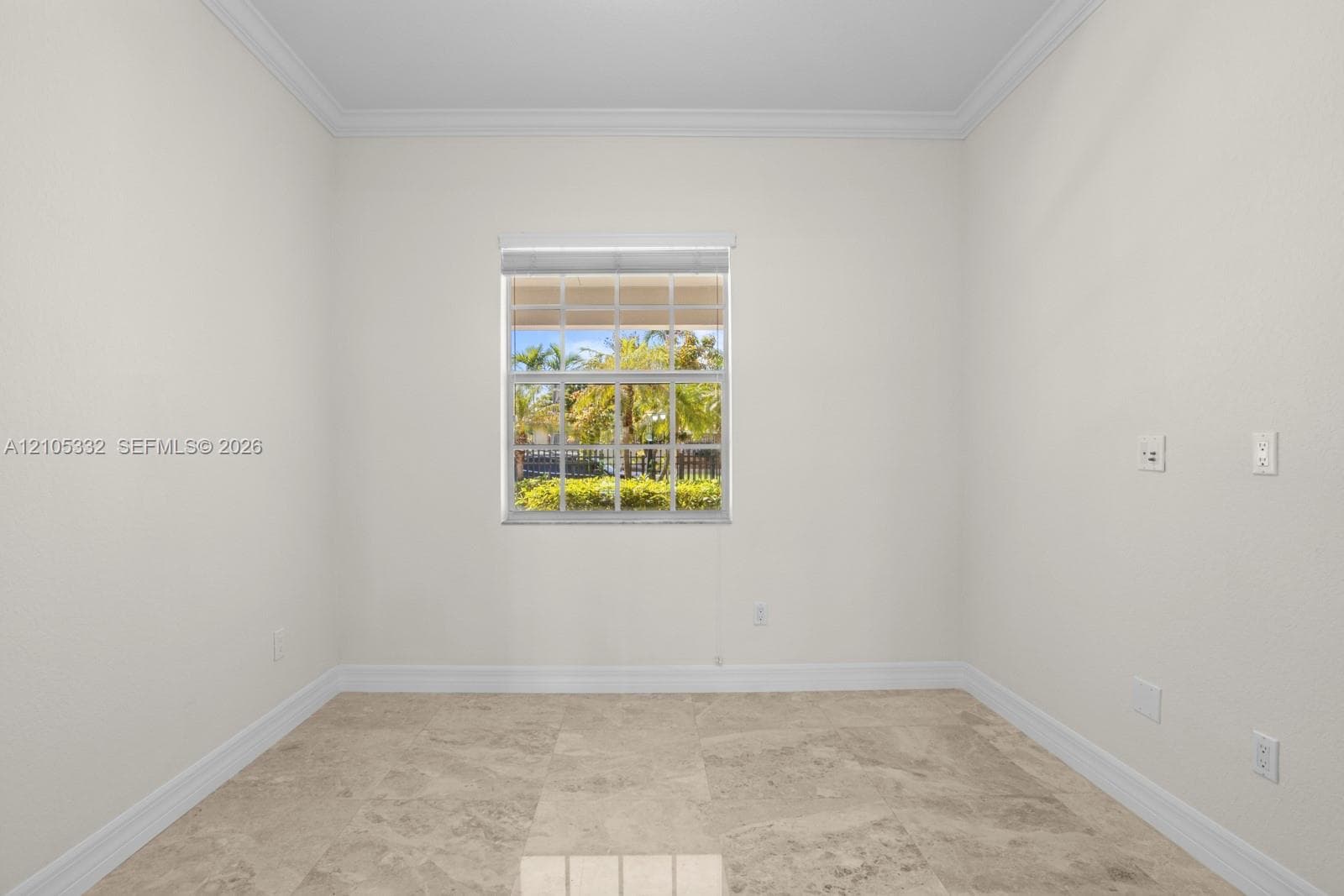 Neutral wall paint, crown molding, a single window with blinds, and tile flooring