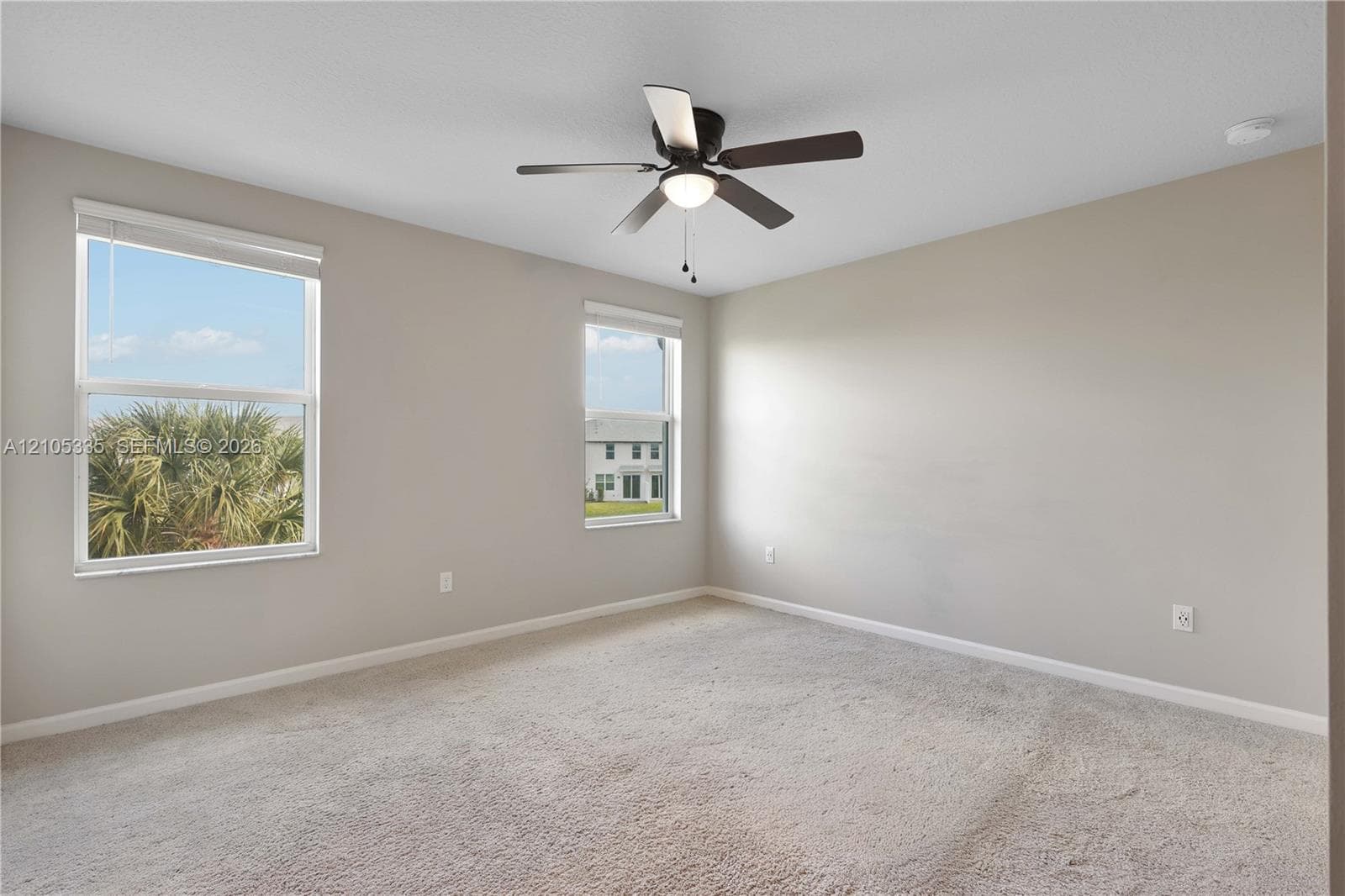 Neutral-toned walls complement the light-colored carpeting