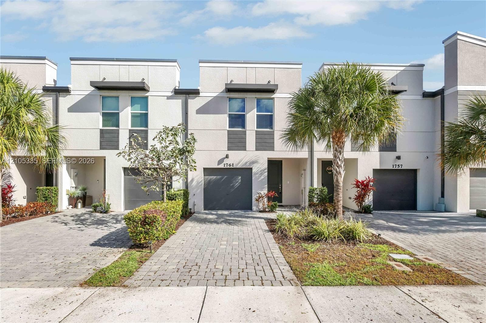Modern townhome exterior featuring clean lines and a neutral color palette