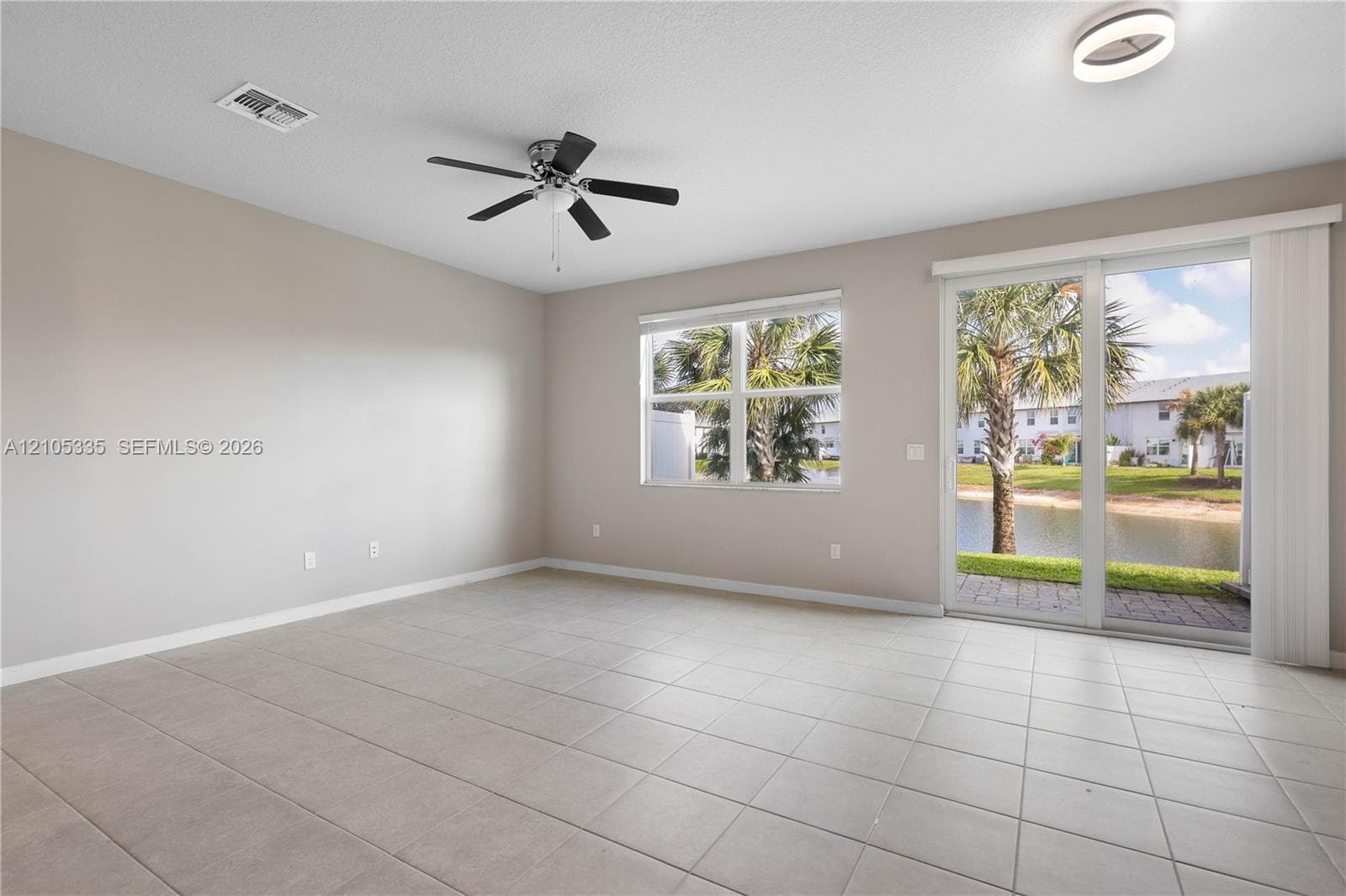 Spacious room with light-colored tile flooring, a ceiling fan, and recessed lighting
