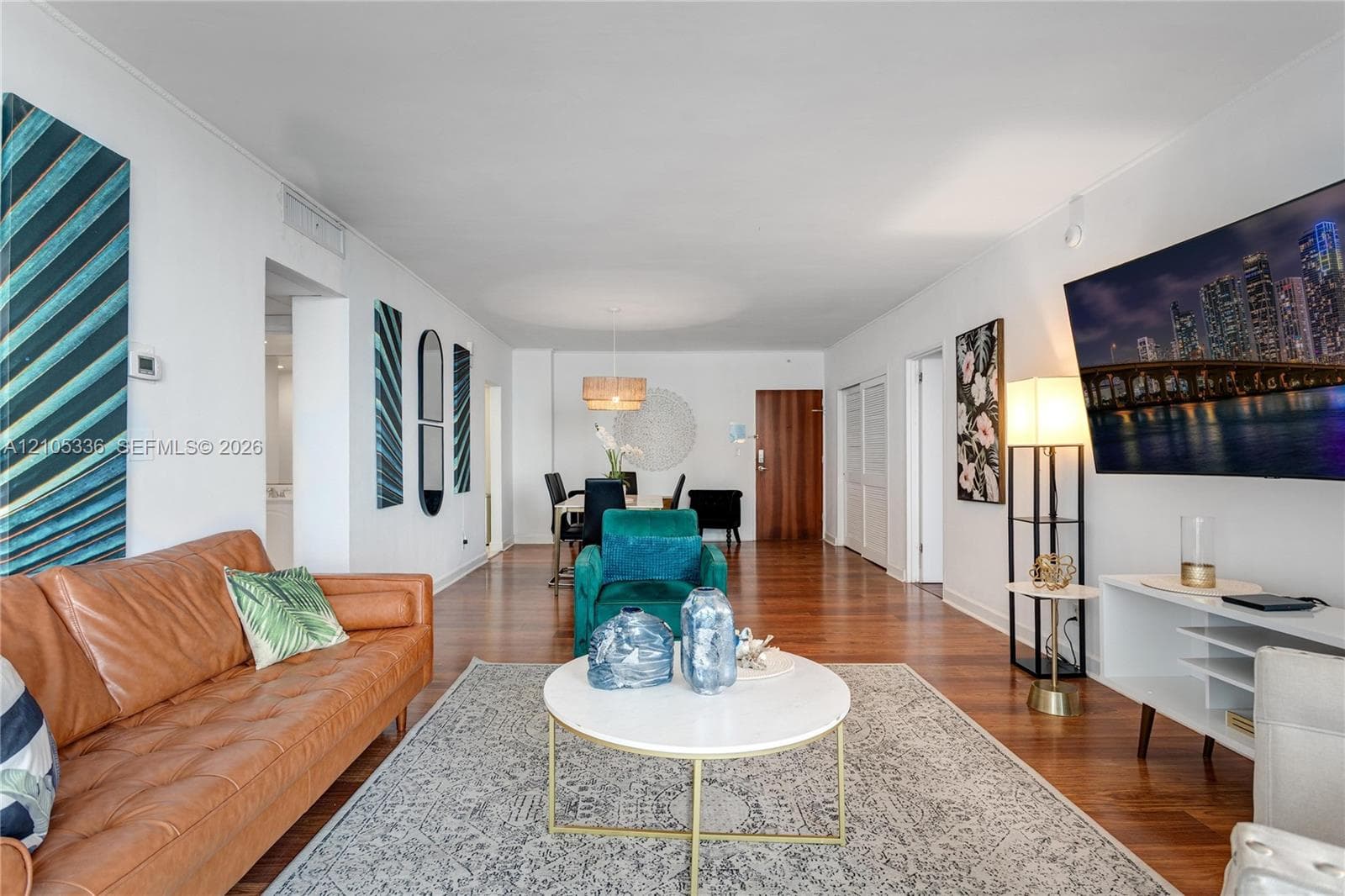 Open-concept interior featuring wood-finish flooring, recessed lighting, and a neutral color palette