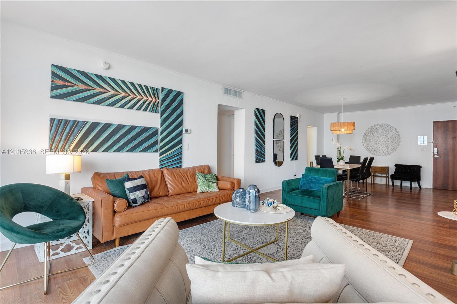 Open-concept interior featuring wood-finish flooring, neutral walls, and recessed lighting