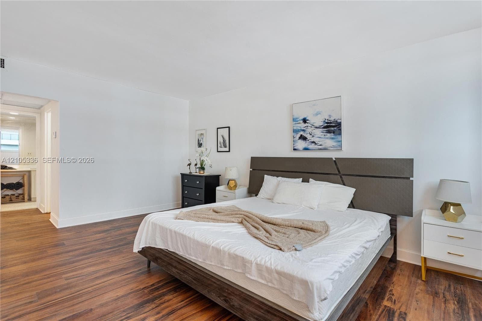 Spacious room featuring wood-finish flooring and neutral wall paint
