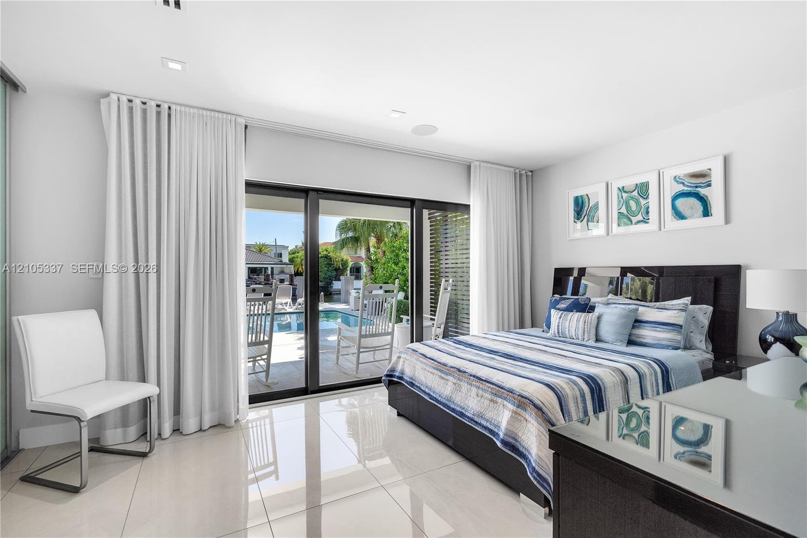 Large-format porcelain tile flooring, sliding glass door system, and recessed ceiling lighting