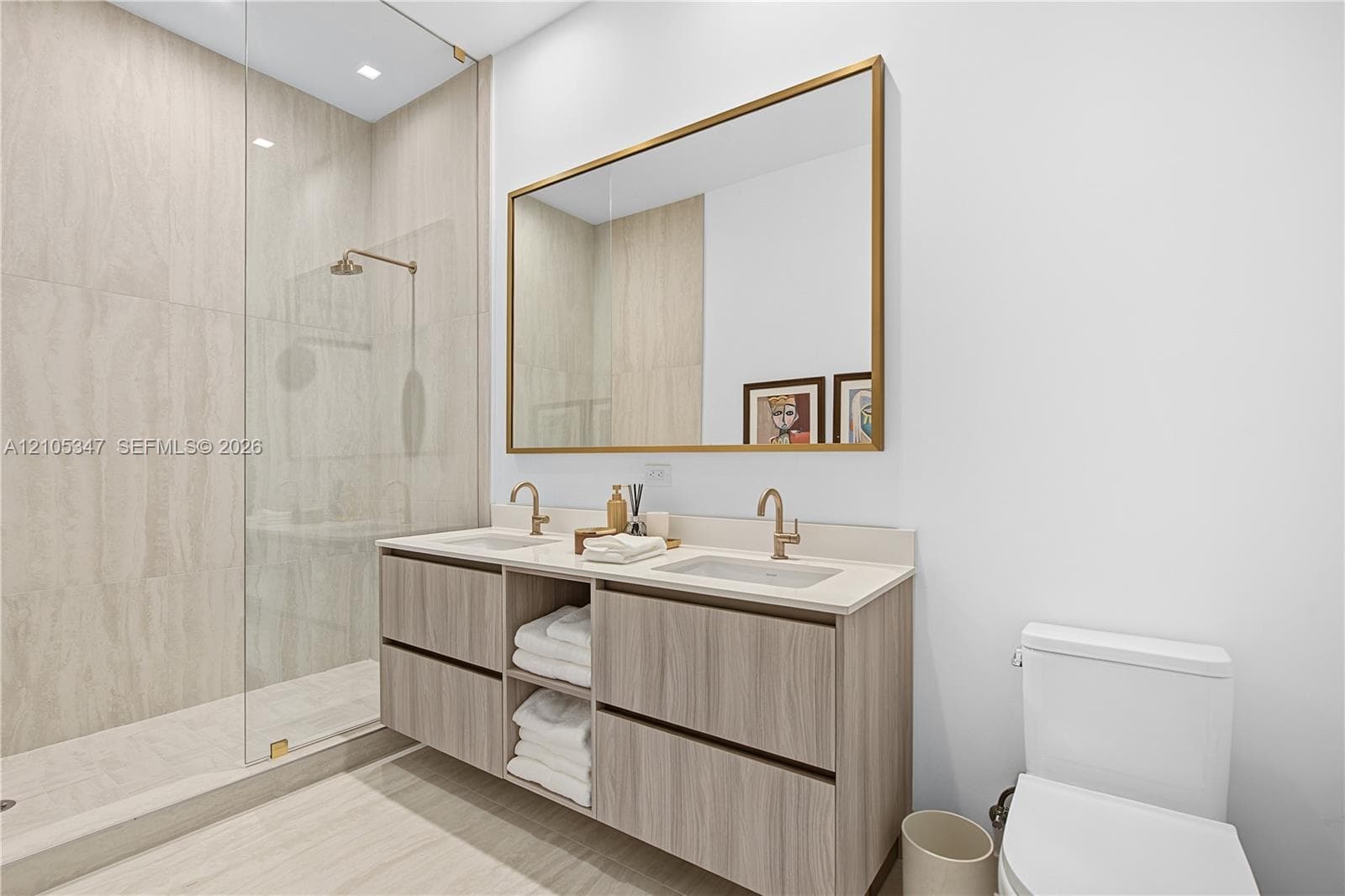 Walk-in shower with tiled walls and glass enclosure