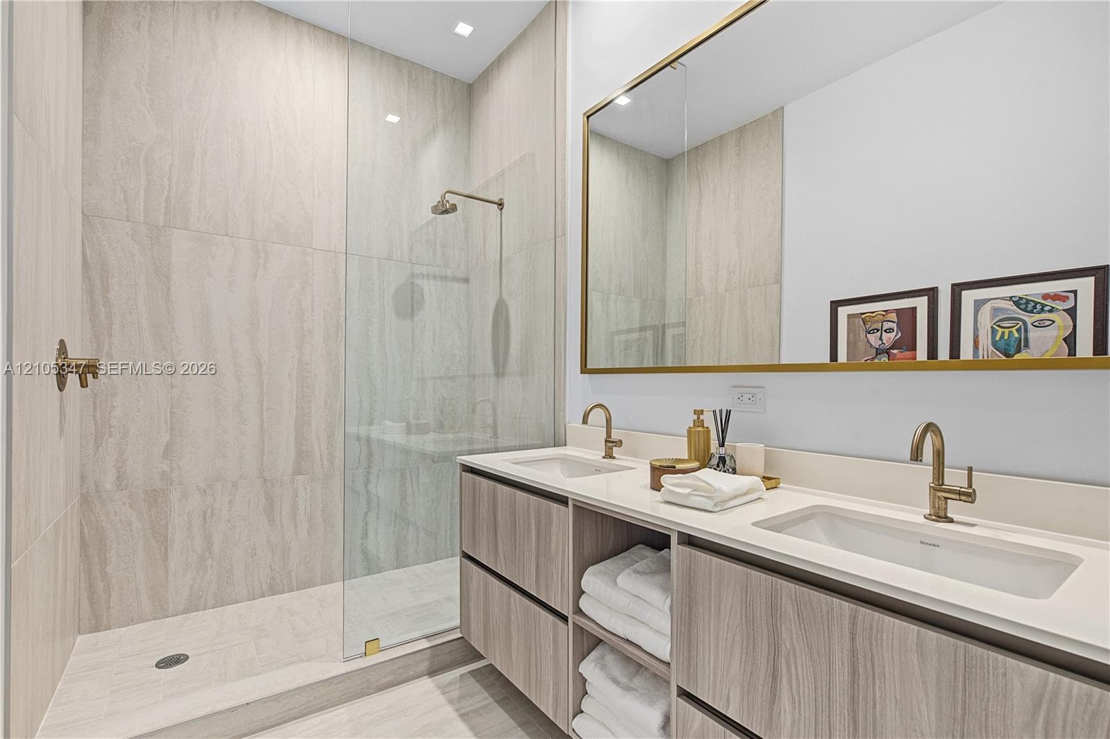 Dual vanities with undermount sinks and brass-finish faucets