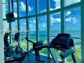Expansive floor-to-ceiling windows with water scenery