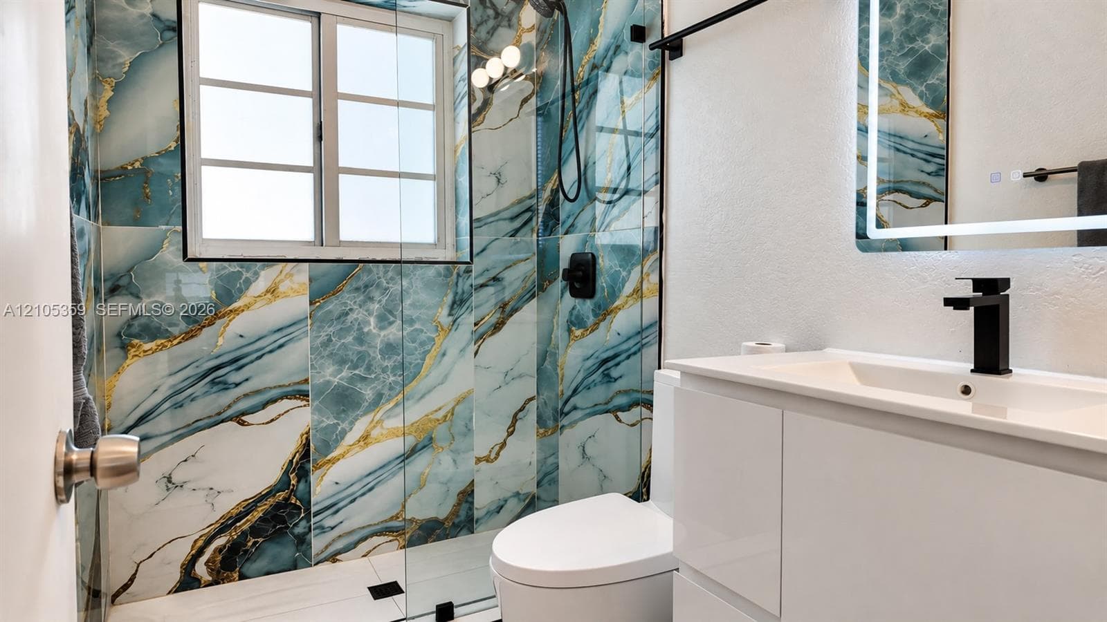Custom tiled shower enclosure, contemporary vanity with integrated sink, black finish plumbing fixtures, illuminated vanity mirror, and window with privacy glass