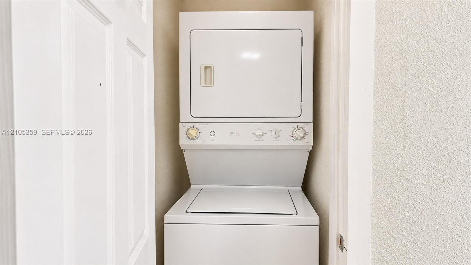 Vertical stackable washer and dryer unit within a dedicated utility closet