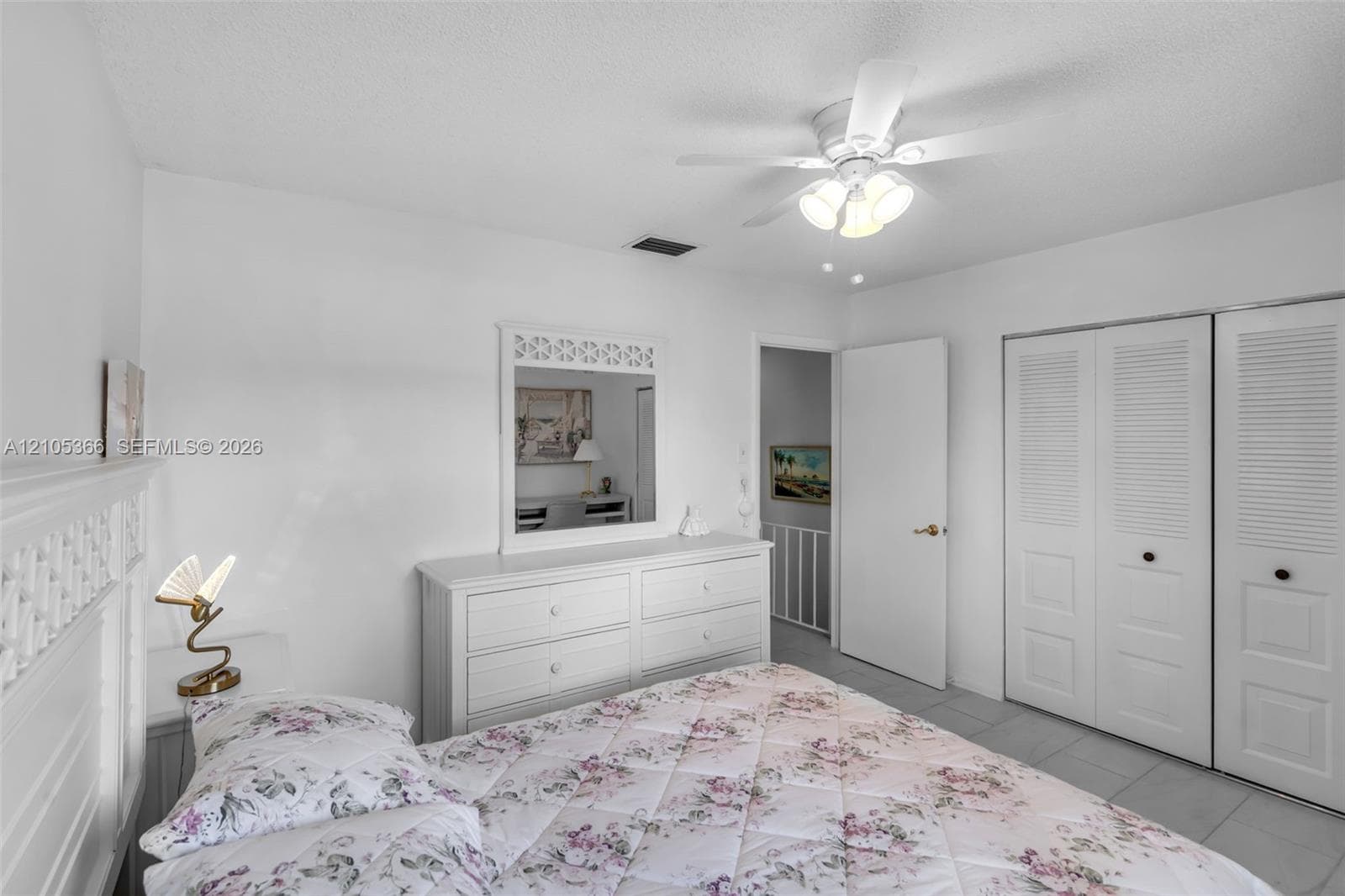 White painted walls with a ceiling fan light fixture