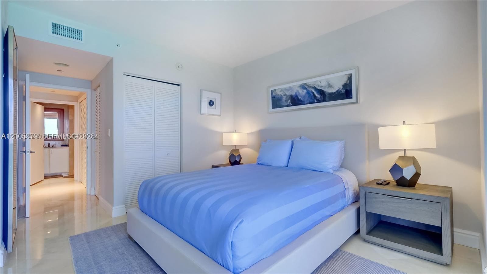 Recessed lighting, louvered closet doors, and light-toned flooring
