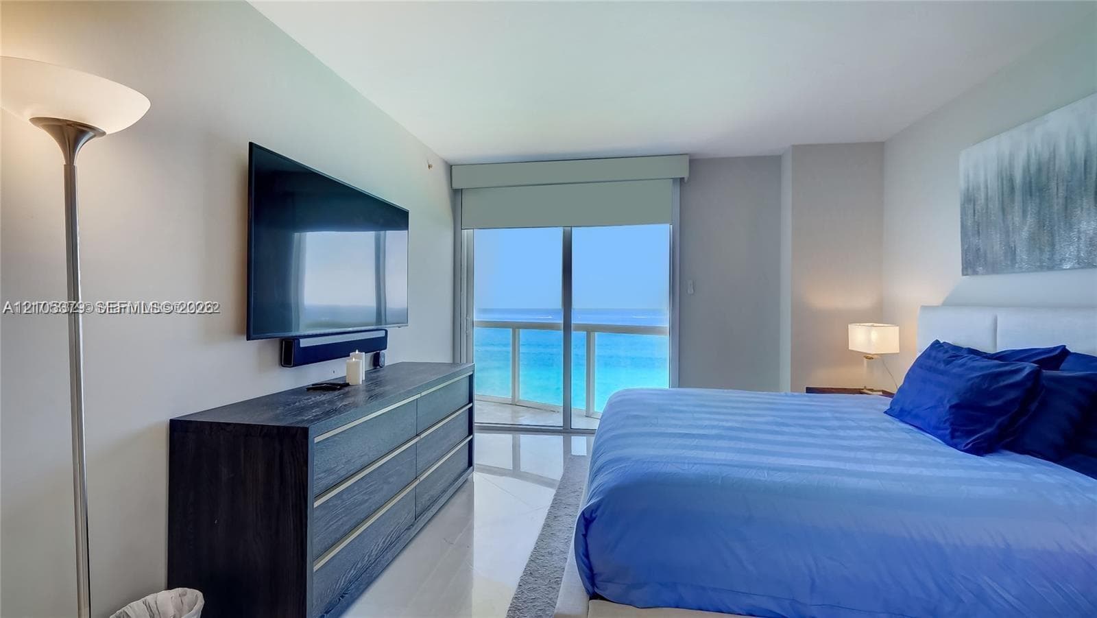Floor-to-ceiling glass sliding doors, hard surface flooring, recessed lighting, and a neutral color palette