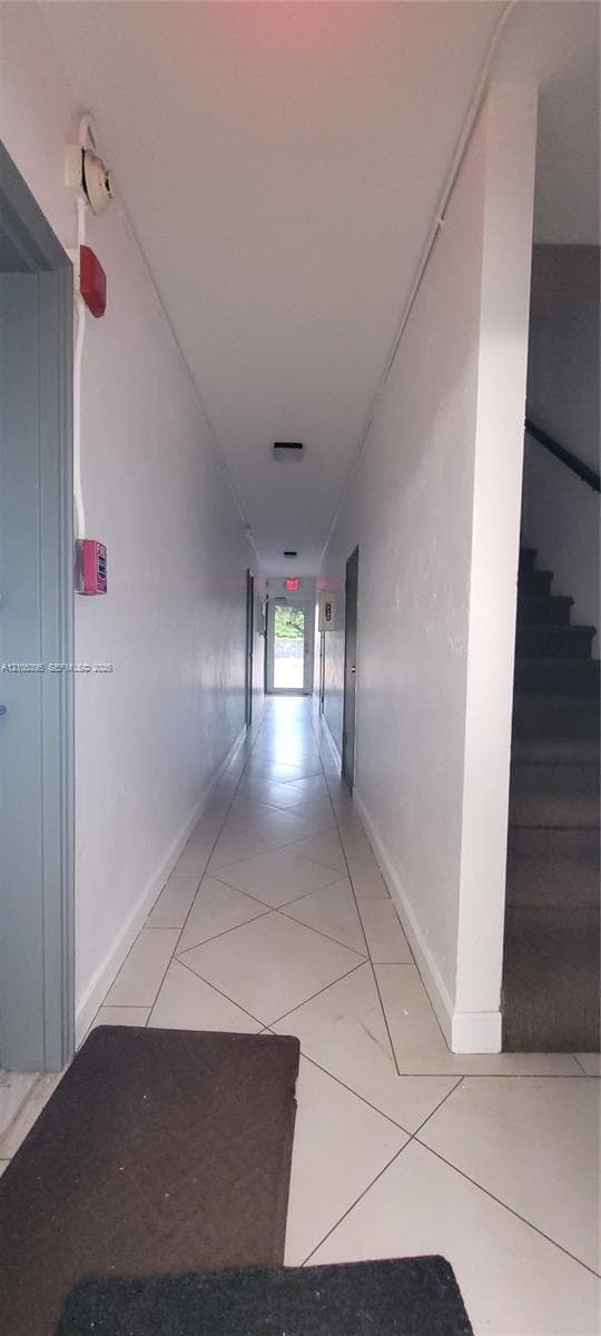 Hallway with tile flooring and painted walls