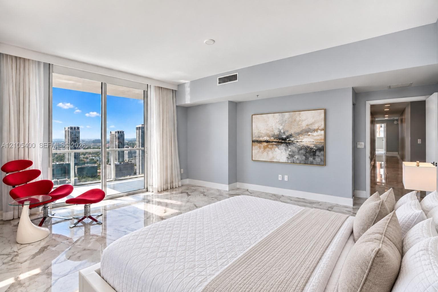 Floor-to-ceiling glass sliding doors, wide plank flooring, and a recessed lighting fixture