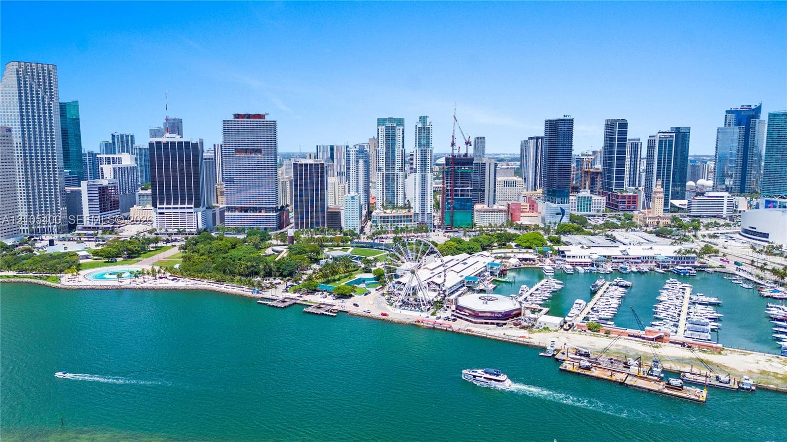 Downtown cityscape with waterfront access, marina, commercial buildings, and recreational park space