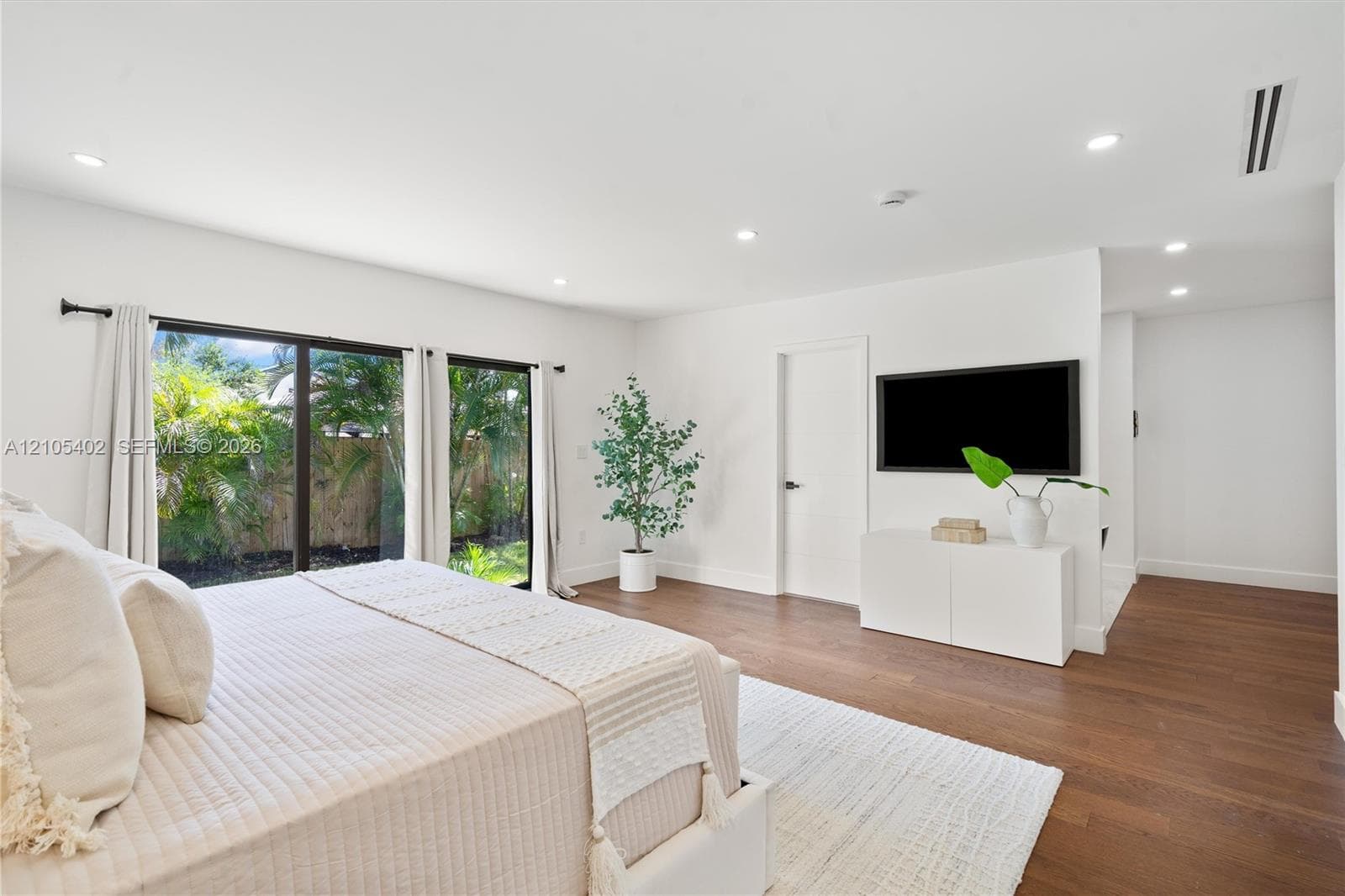 Interior space featuring wood-finish flooring, recessed lighting, and large sliding glass doors