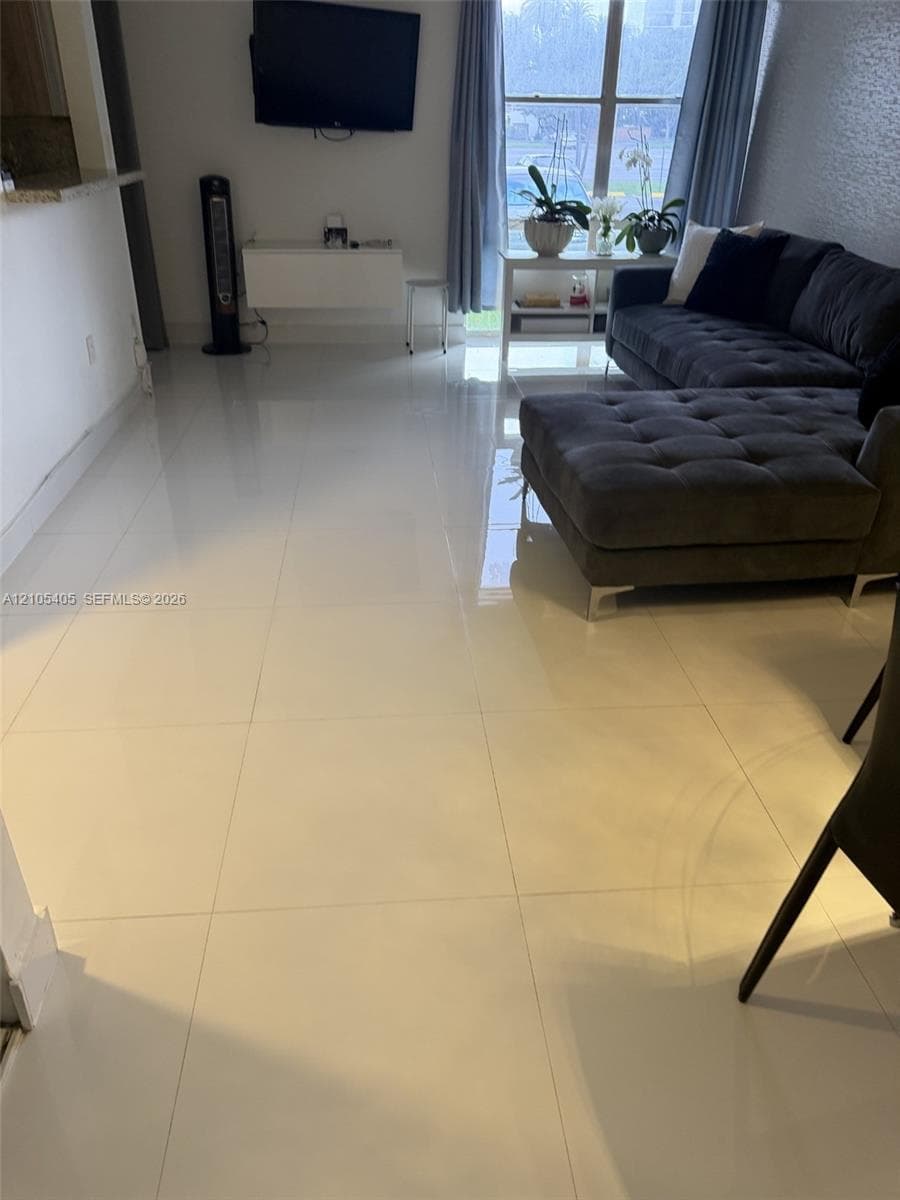 White tile flooring extends throughout the space