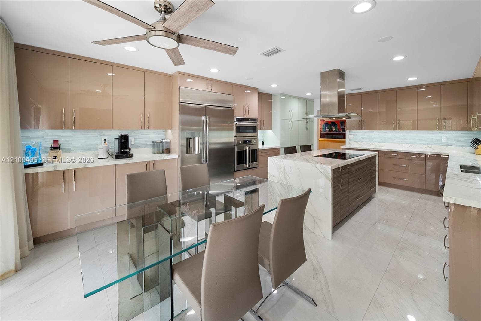 Kitchen featuring an expansive center island, stainless steel appliances, recessed lighting, and a ceiling fan