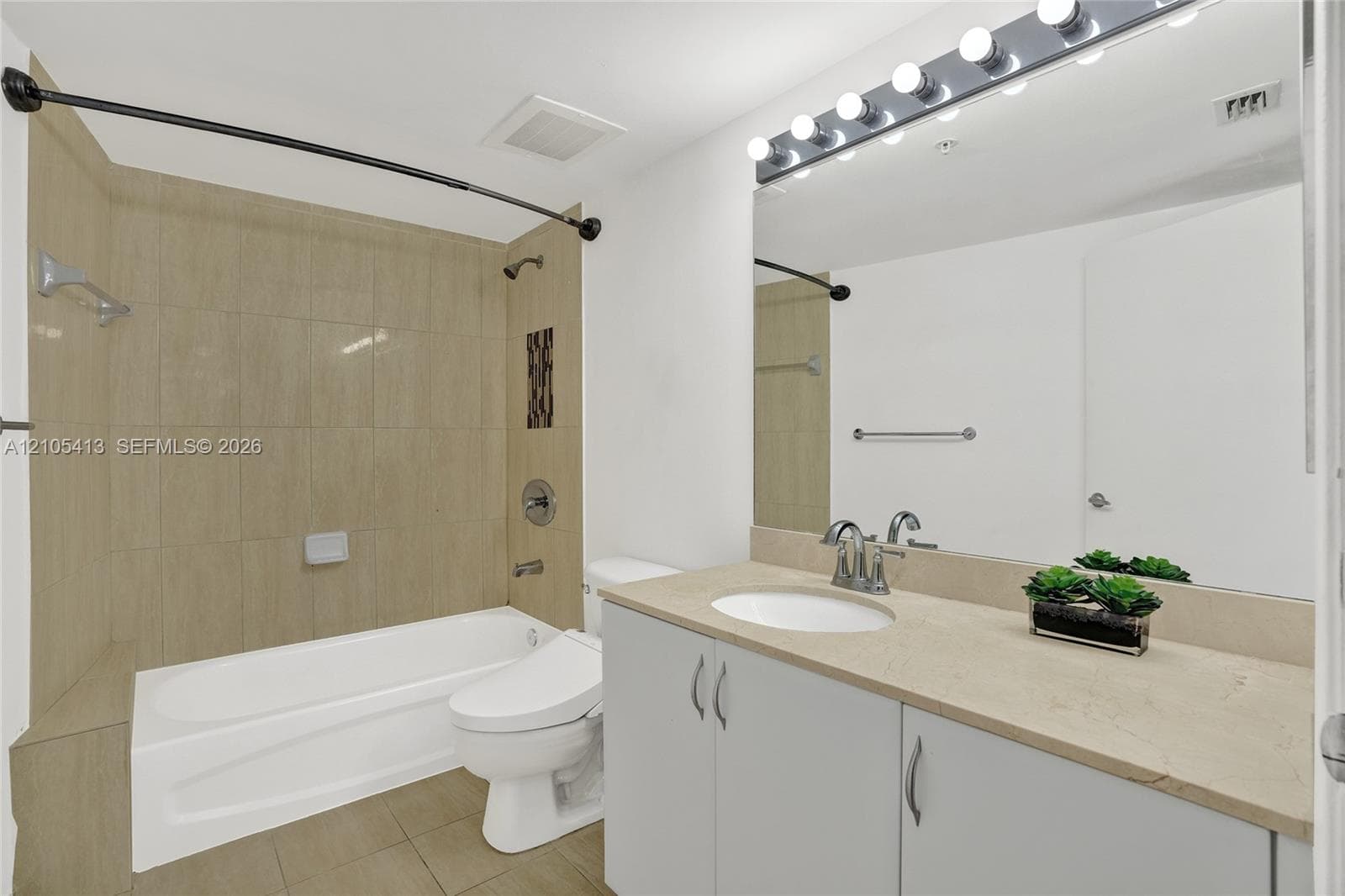 Vanity with an integrated sink, polished chrome faucet, and ample storage cabinetry
