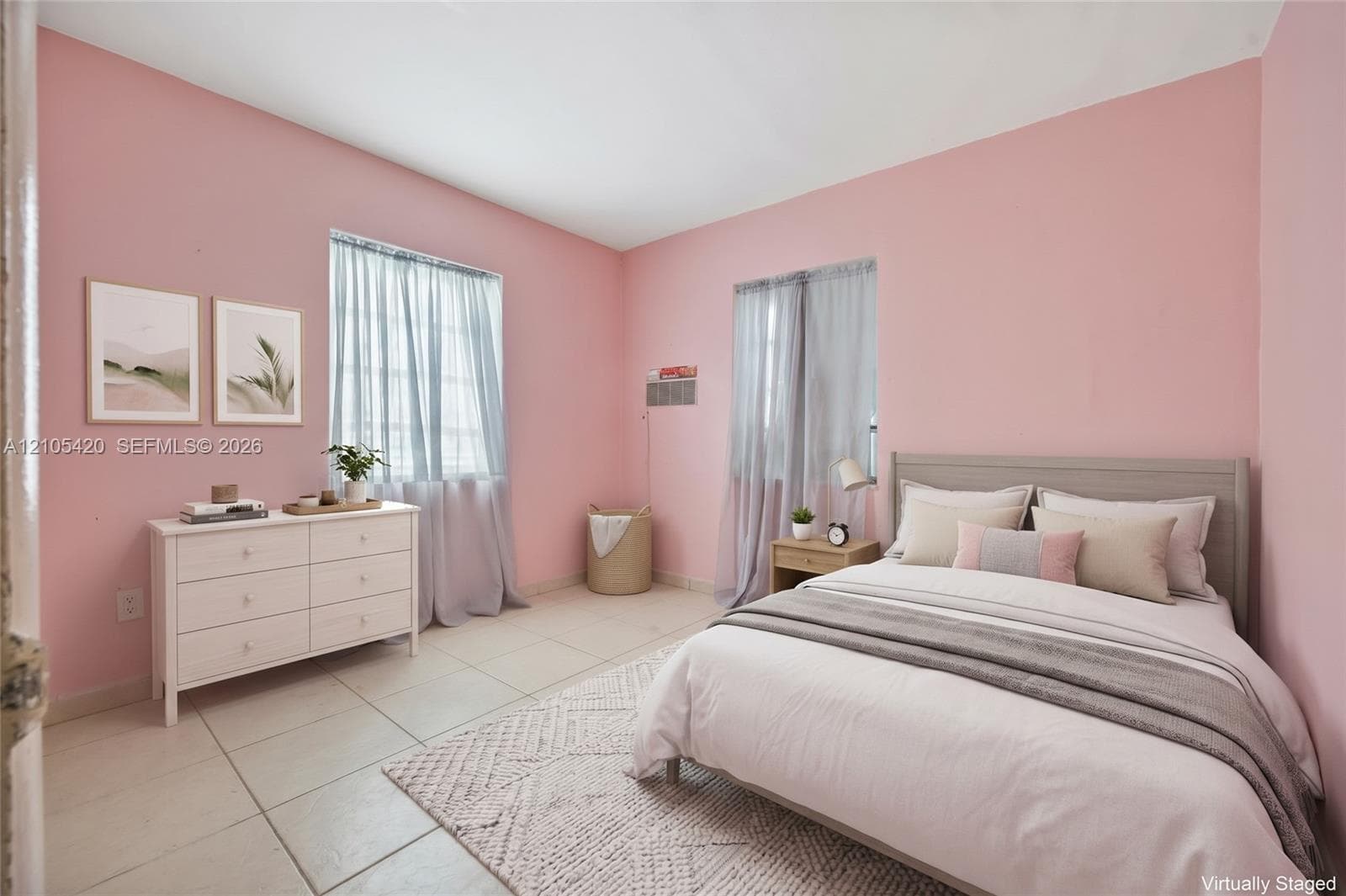 Light-colored tile flooring, neutral-toned walls, and multiple windows with sheer drapery
