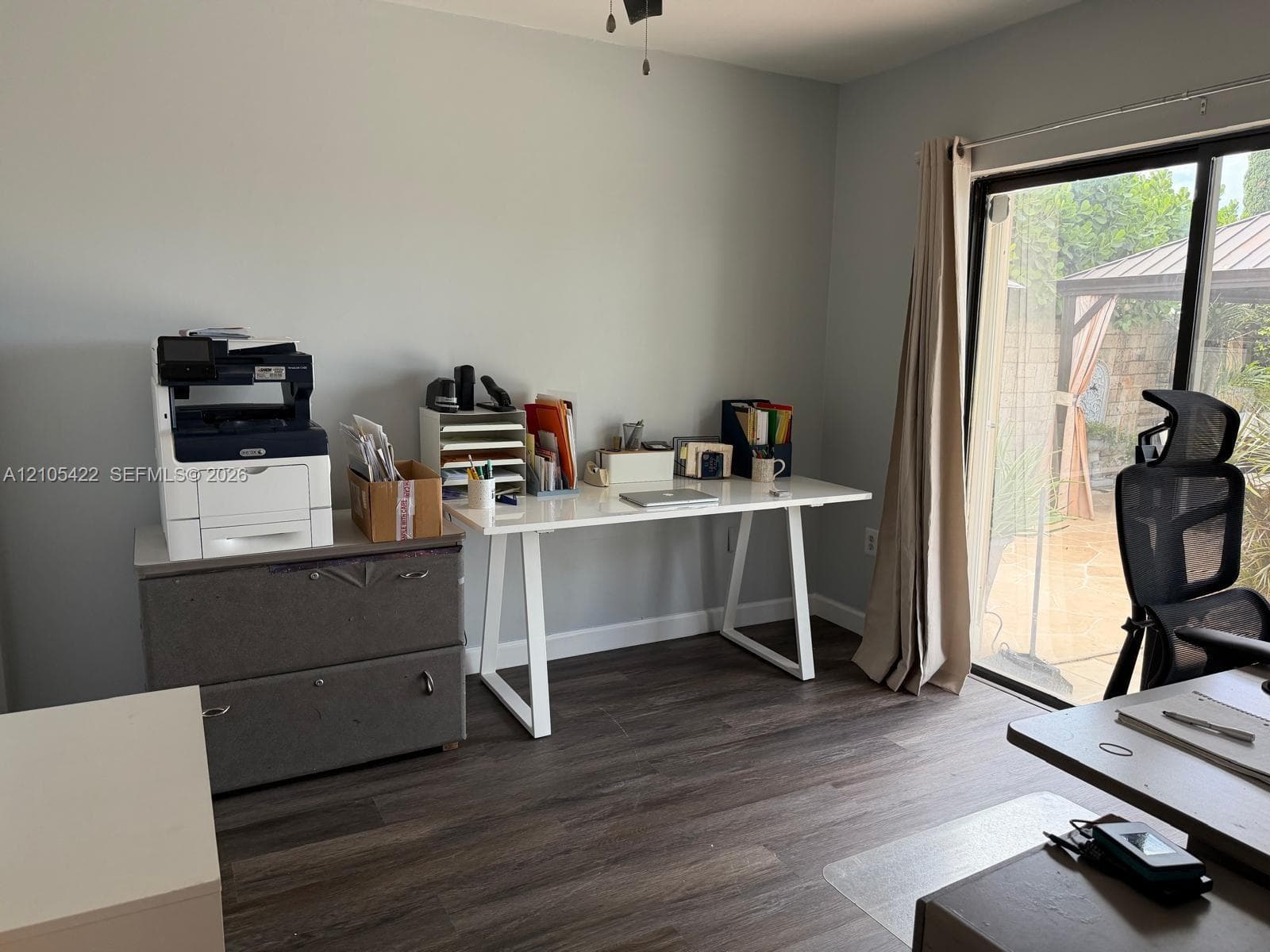 Room featuring wood-finish flooring and a sliding glass door providing access to an outdoor patio