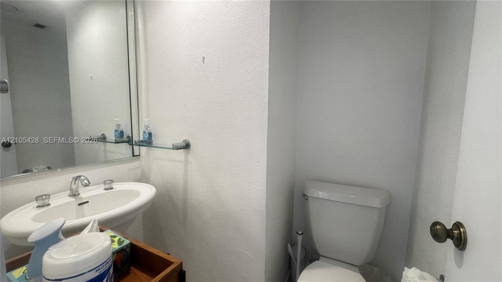 Pedestal sink, white tile flooring, recessed lighting, and a built-in tub with shower