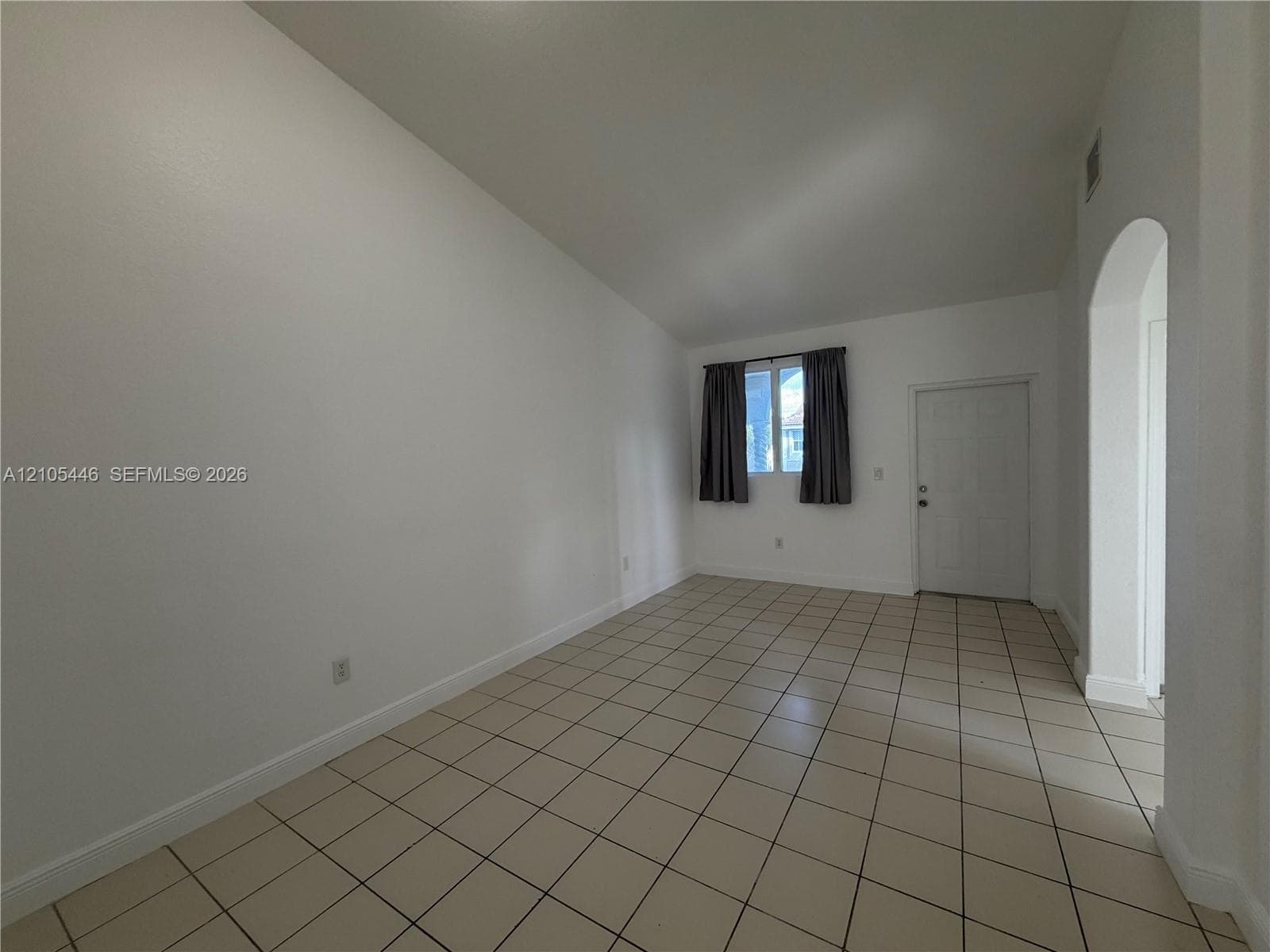 Double stainless steel sink, solid surface countertops, built-in dishwasher, white cabinetry, and bay windows