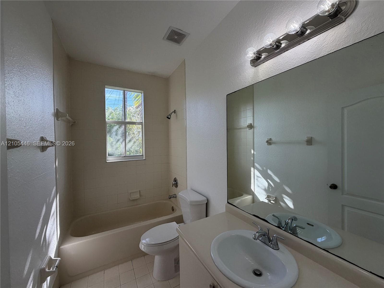 Wood-finish flooring, white walls, bi-fold closet doors, wire shelving, and a recessed ceiling light