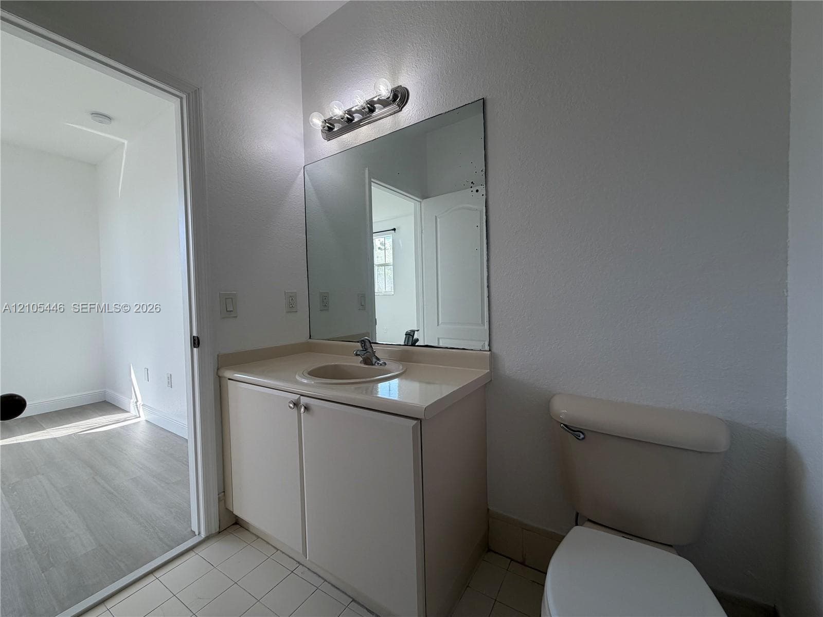 Bathtub with tiled surround, showerhead, and chrome fixtures
