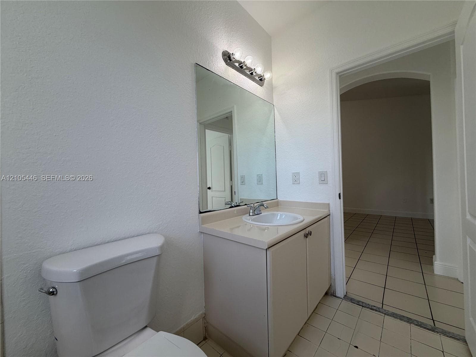 Bathtub with tile surround, a window, and chrome fixtures