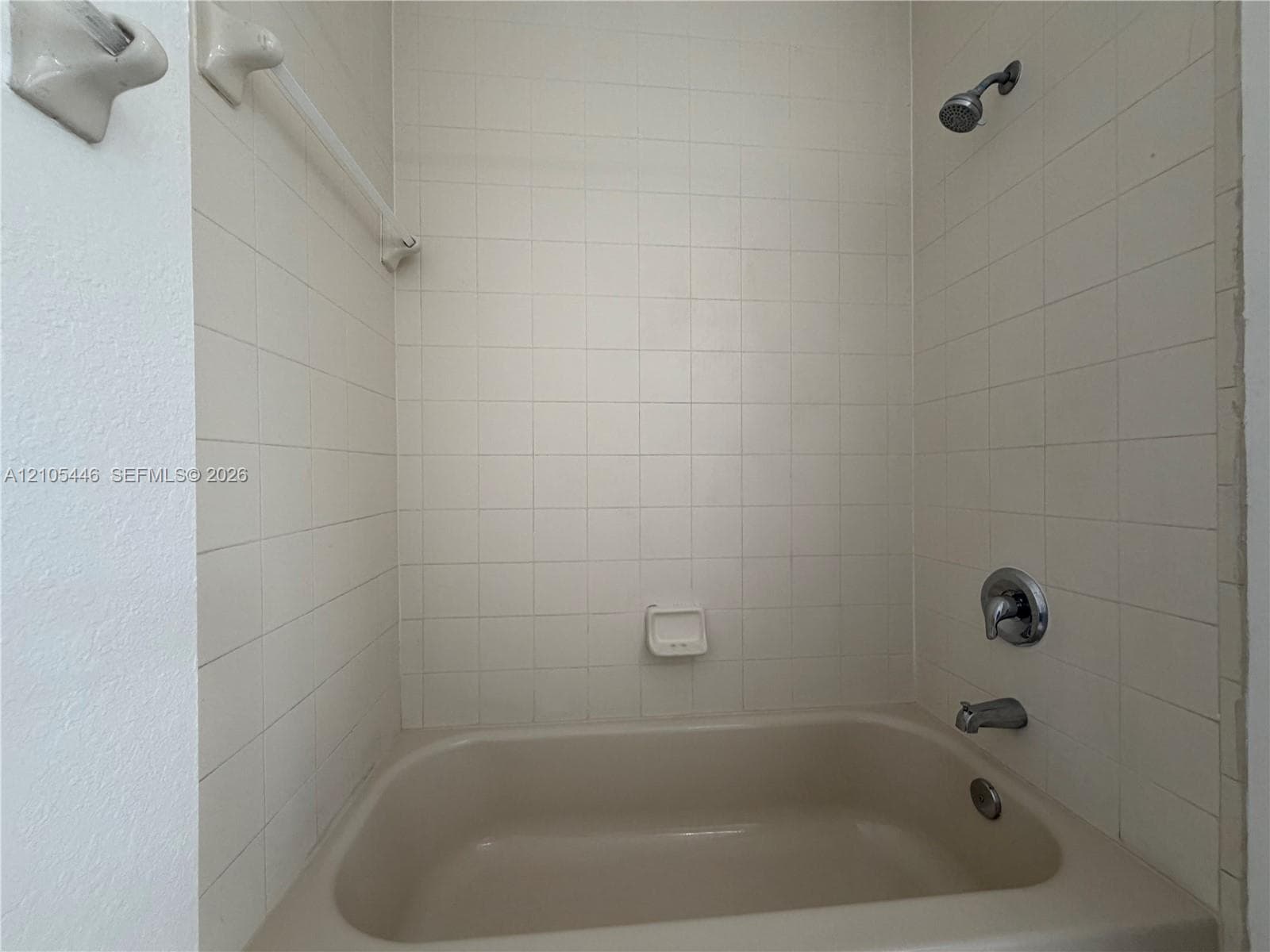 Vanity with integrated sink, chrome faucet, and expansive mirror
